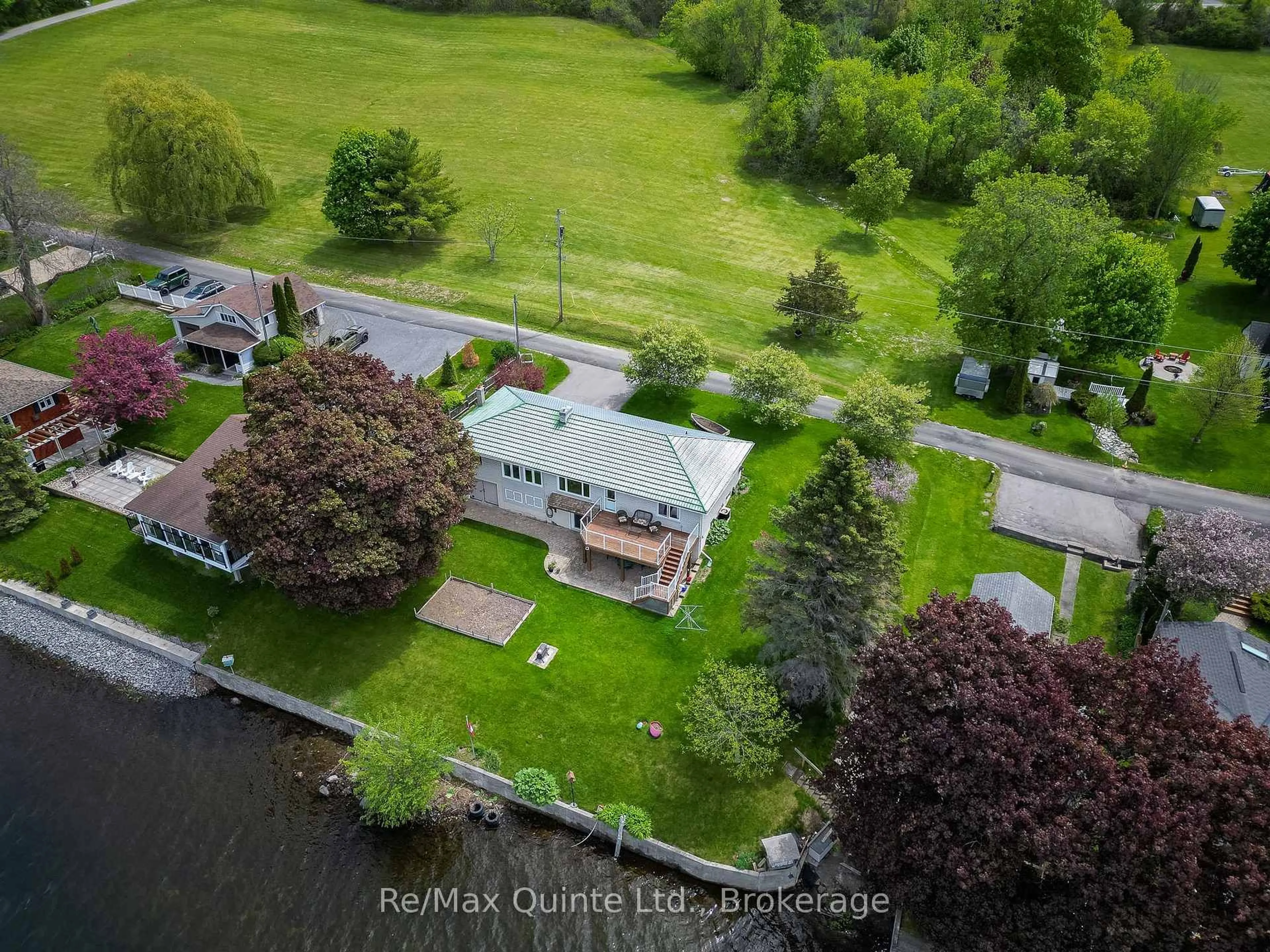 A pic from outside/outdoor area/front of a property/back of a property/a pic from drone, water/lake/river/ocean view for 54 Cedar Lane, Prince Edward County Ontario K0K 2T0