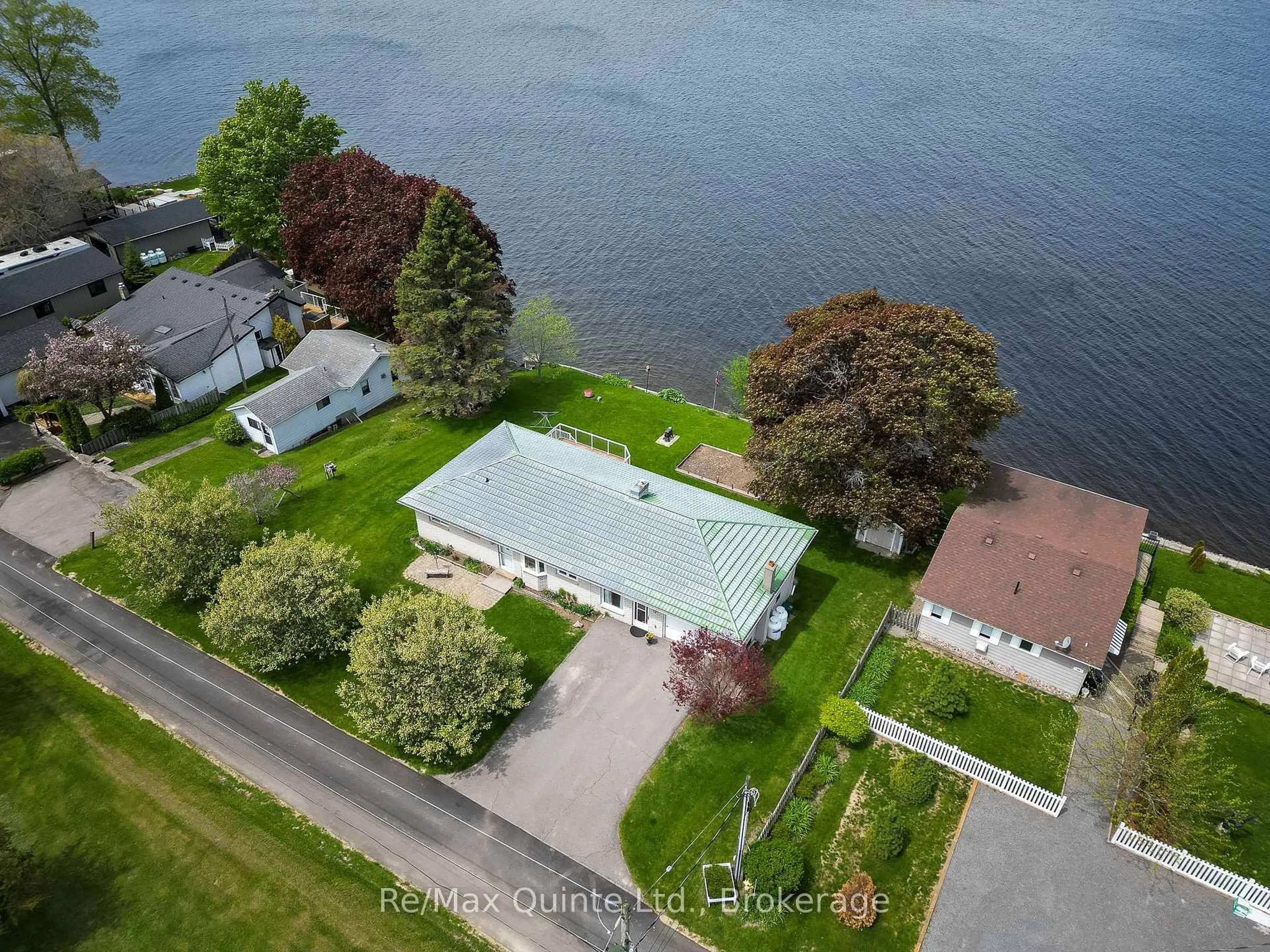 A pic from outside/outdoor area/front of a property/back of a property/a pic from drone, water/lake/river/ocean view for 54 Cedar Lane, Prince Edward County Ontario K0K 2T0