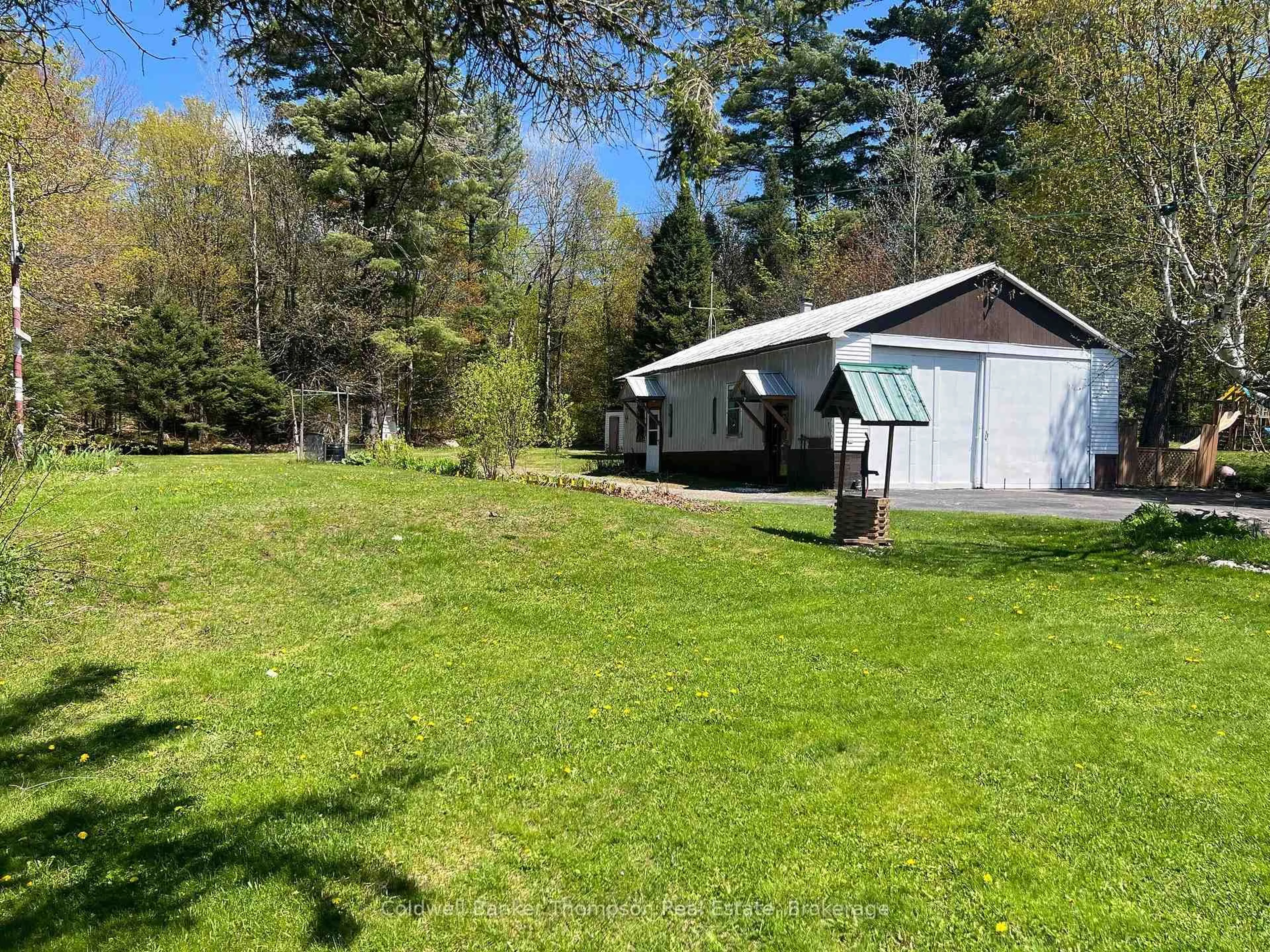 A pic from outside/outdoor area/front of a property/back of a property/a pic from drone, water/lake/river/ocean view for 37 Eagle Lake Rd, South River Ontario P0A 1X0