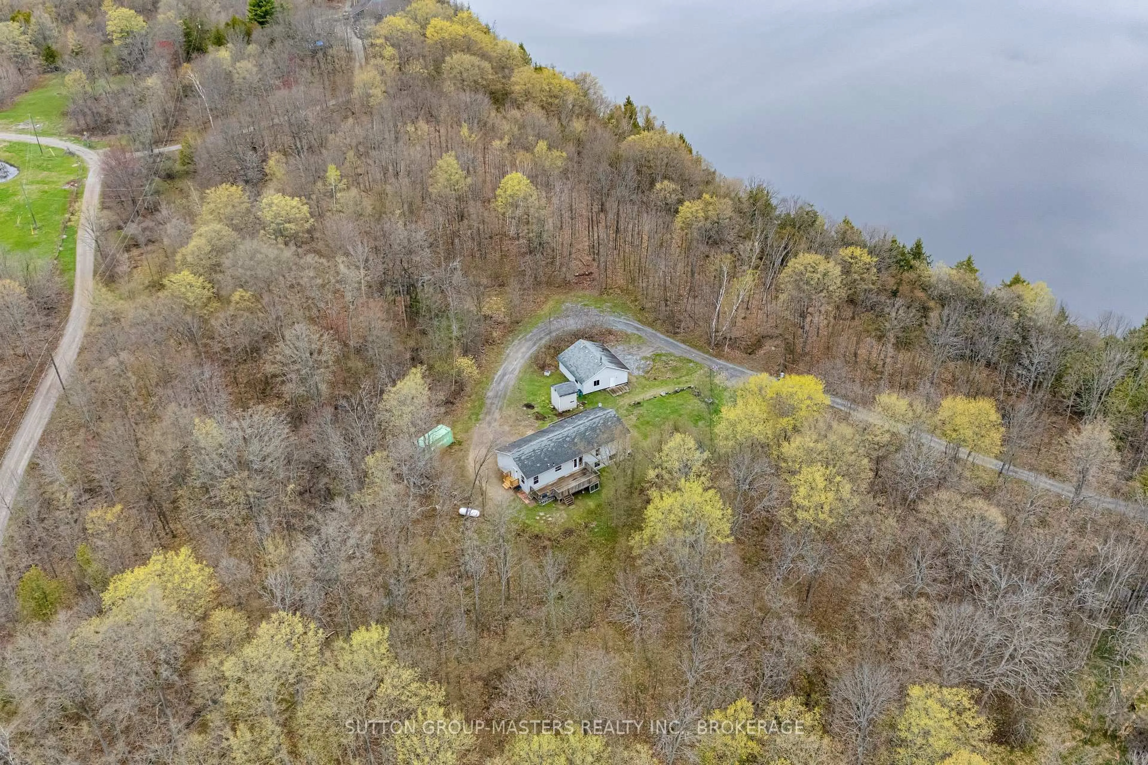 A pic from outside/outdoor area/front of a property/back of a property/a pic from drone, water/lake/river/ocean view for 1140 St. Georges Lake Rd, Maberly Ontario K0H 2B0