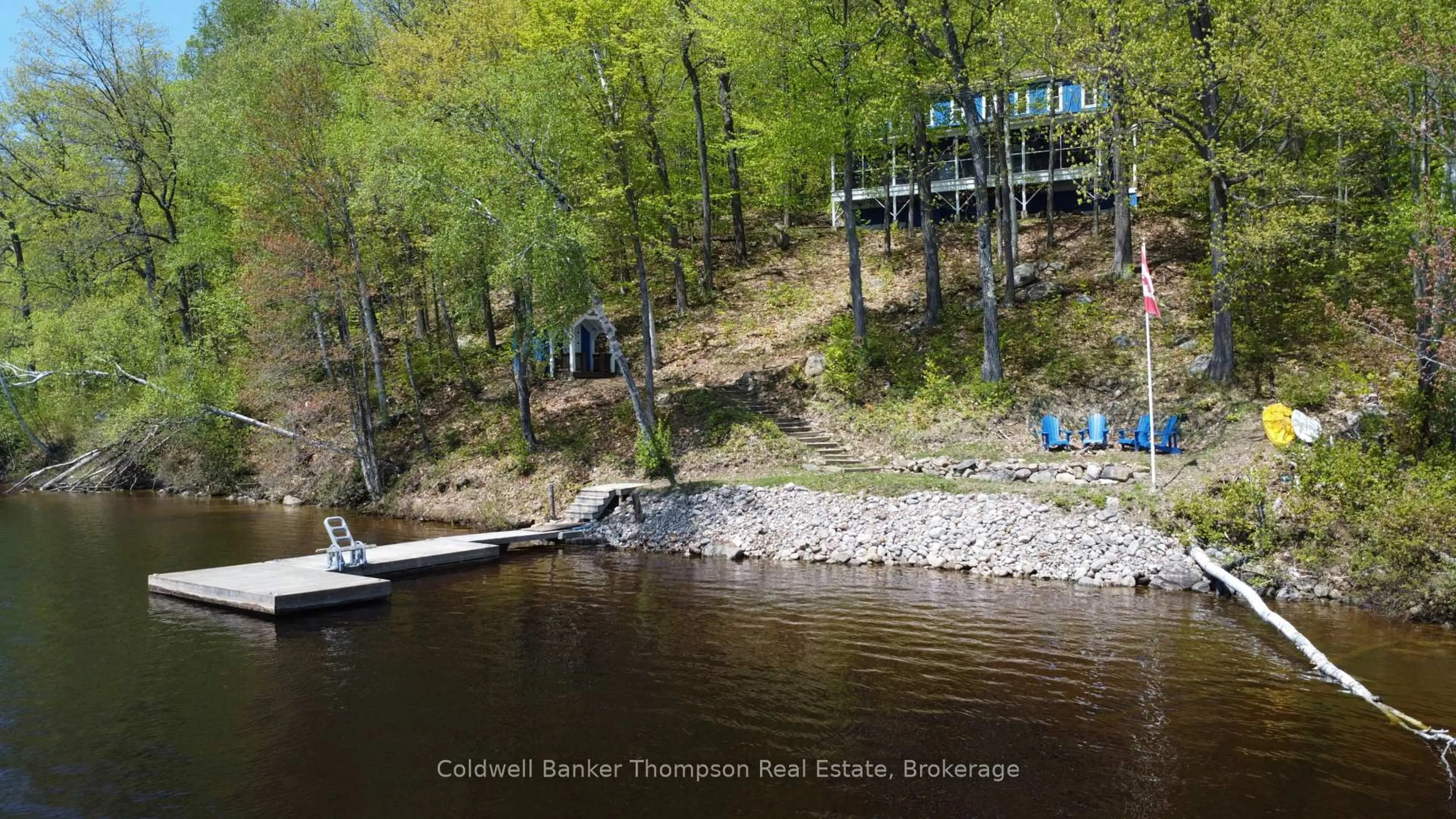 A pic from outside/outdoor area/front of a property/back of a property/a pic from drone, water/lake/river/ocean view for 768 Big Island, Huntsville Ontario P1H 2J2