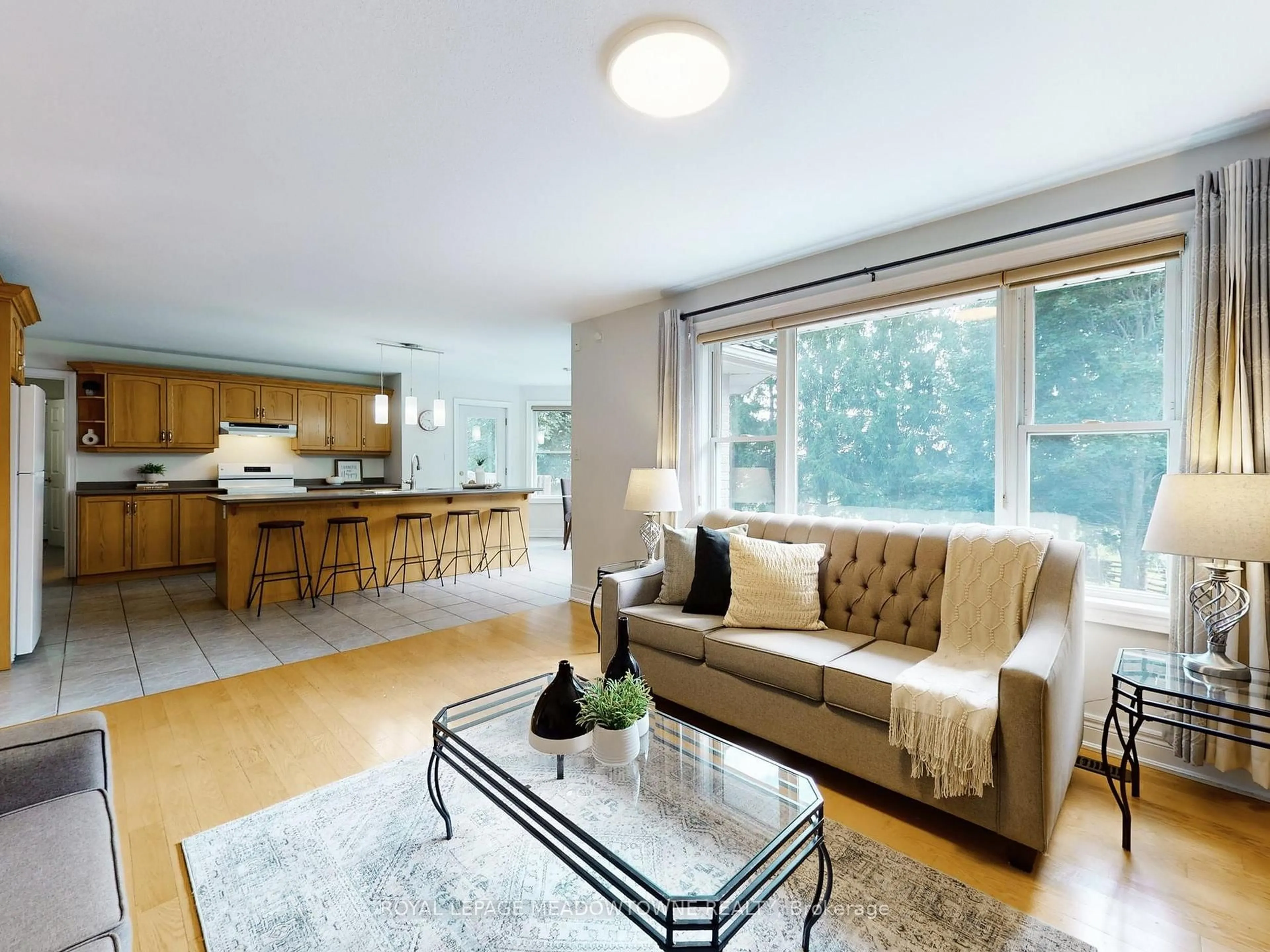 Living room with furniture, wood/laminate floor for 4958 Wellington Road 125, Erin Ontario L7J 2L9