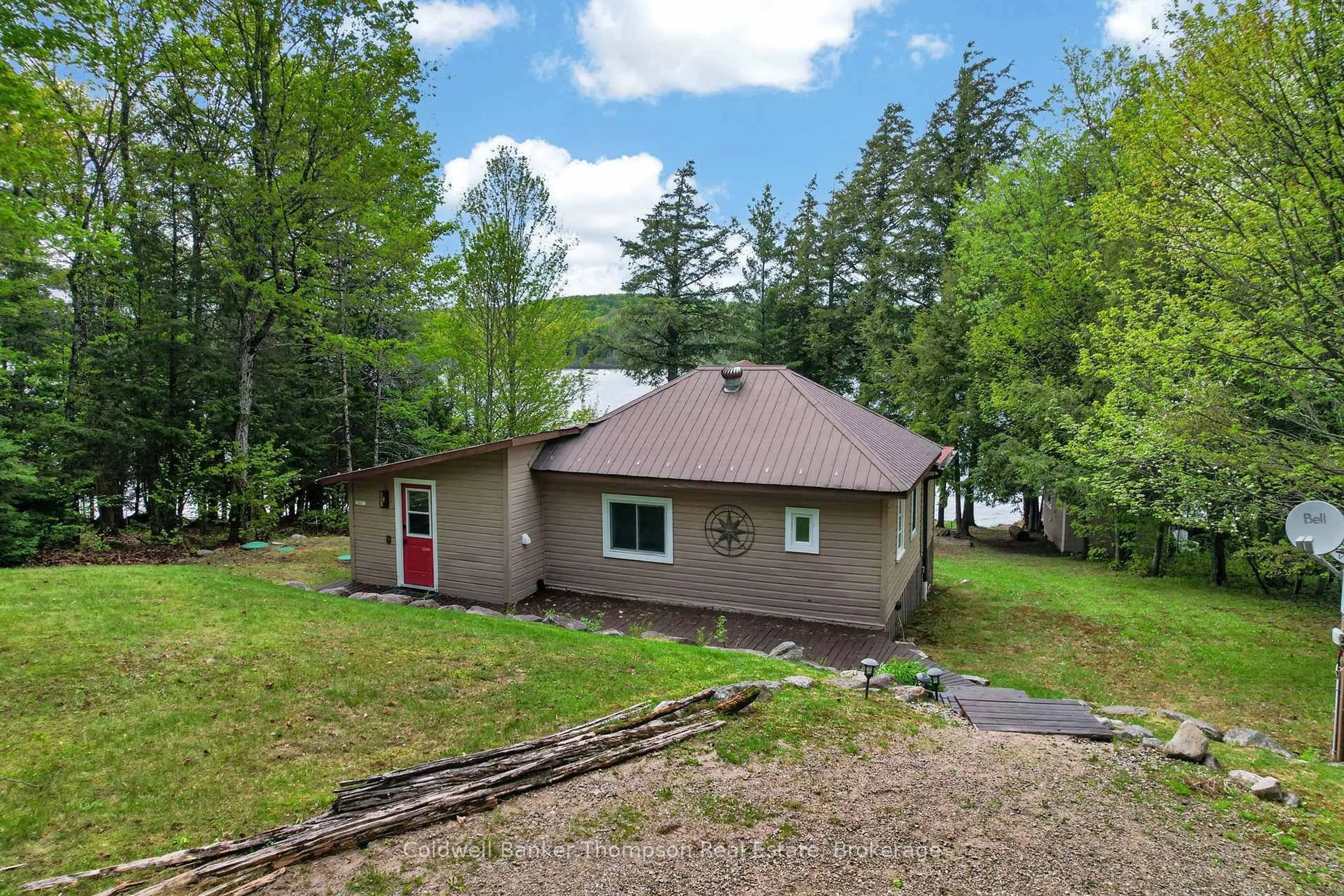 A pic from outside/outdoor area/front of a property/back of a property/a pic from drone, water/lake/river/ocean view for 112 Bittern Lake Lane, Perry Ontario P0A 1R0