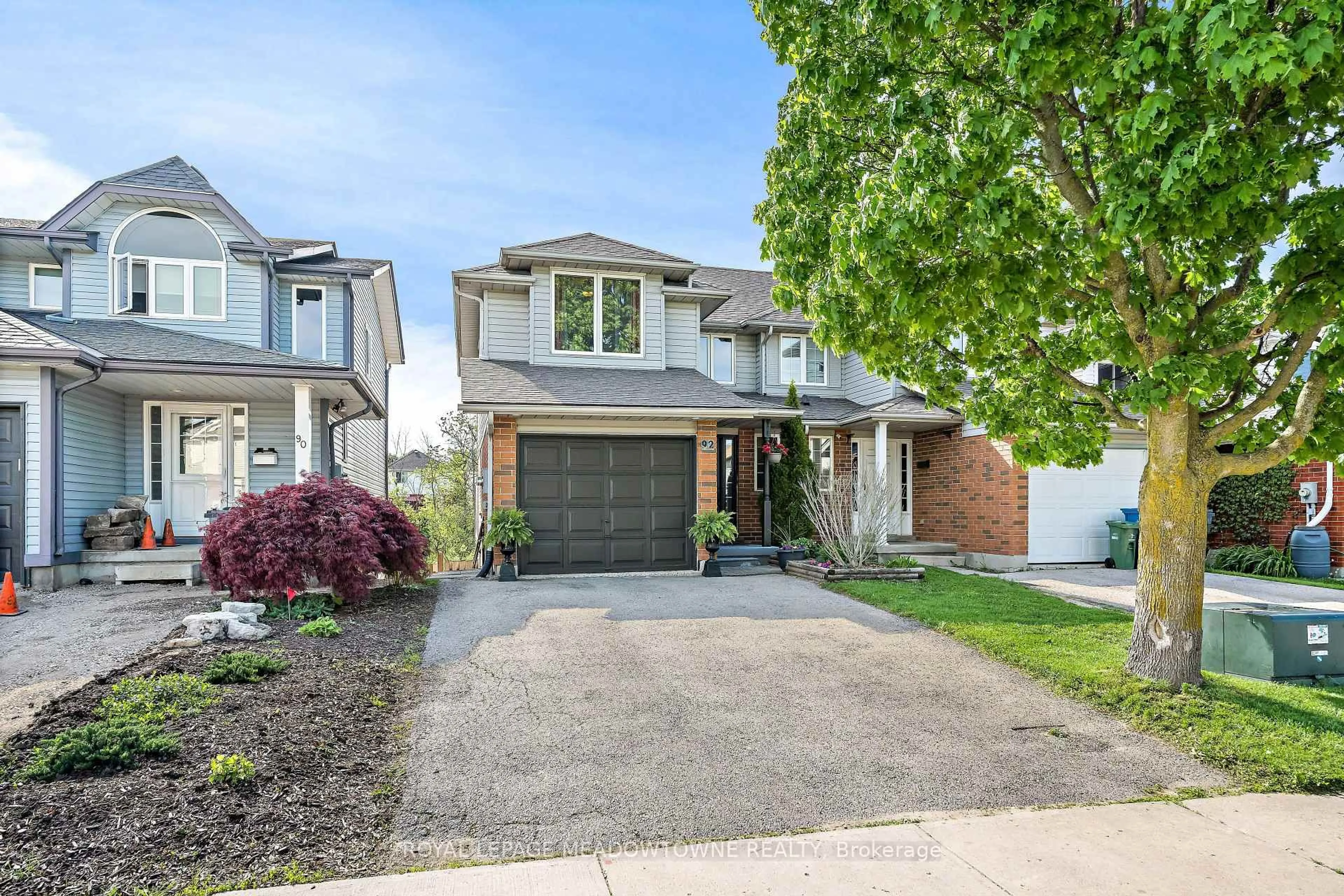 Home with brick exterior material, street for 92 Chesterton Lane, Guelph Ontario N1E 7A6