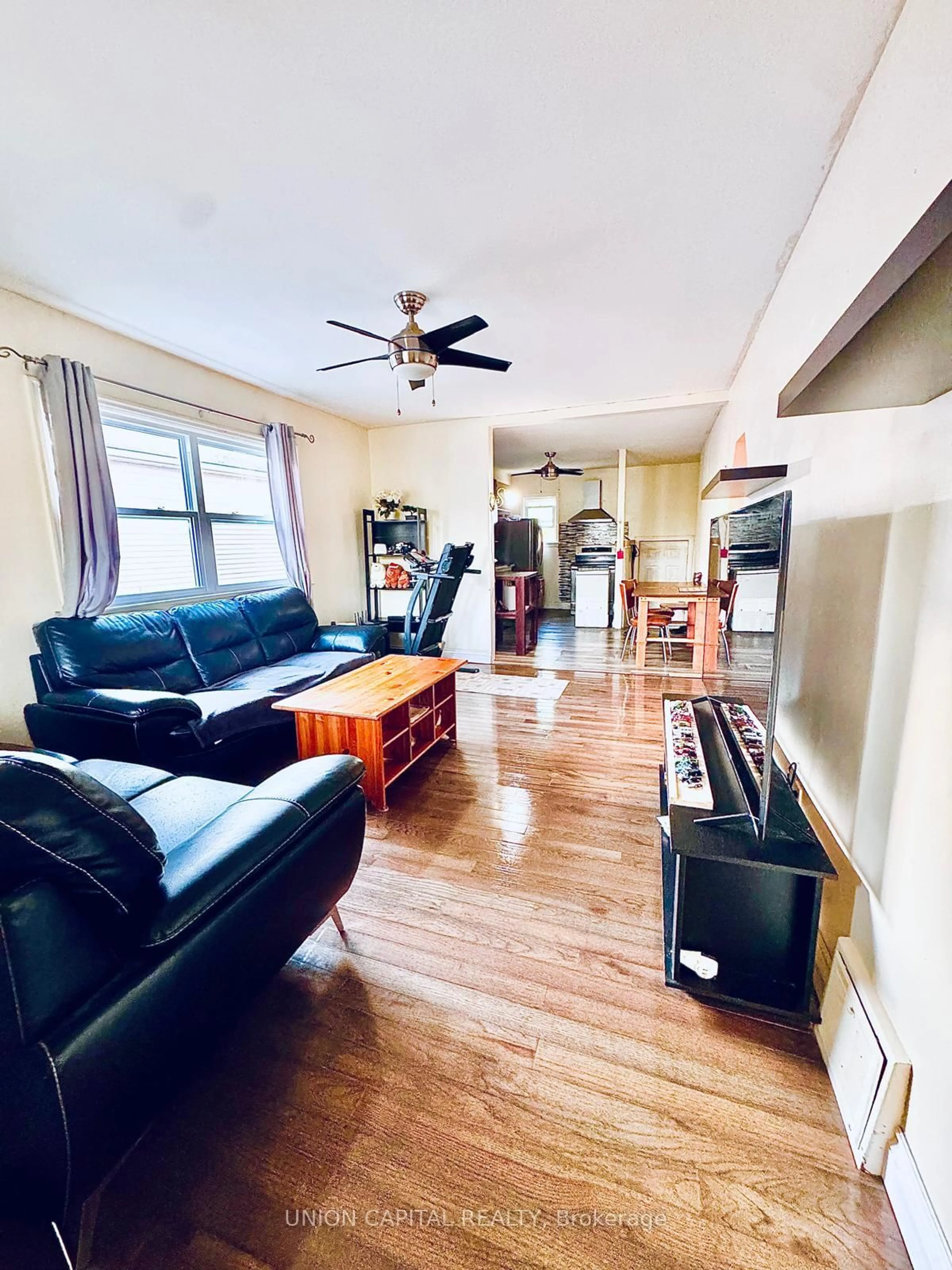 Living room with furniture, wood/laminate floor for 16 Cumming St, St. Catharines Ontario L2S 1H7