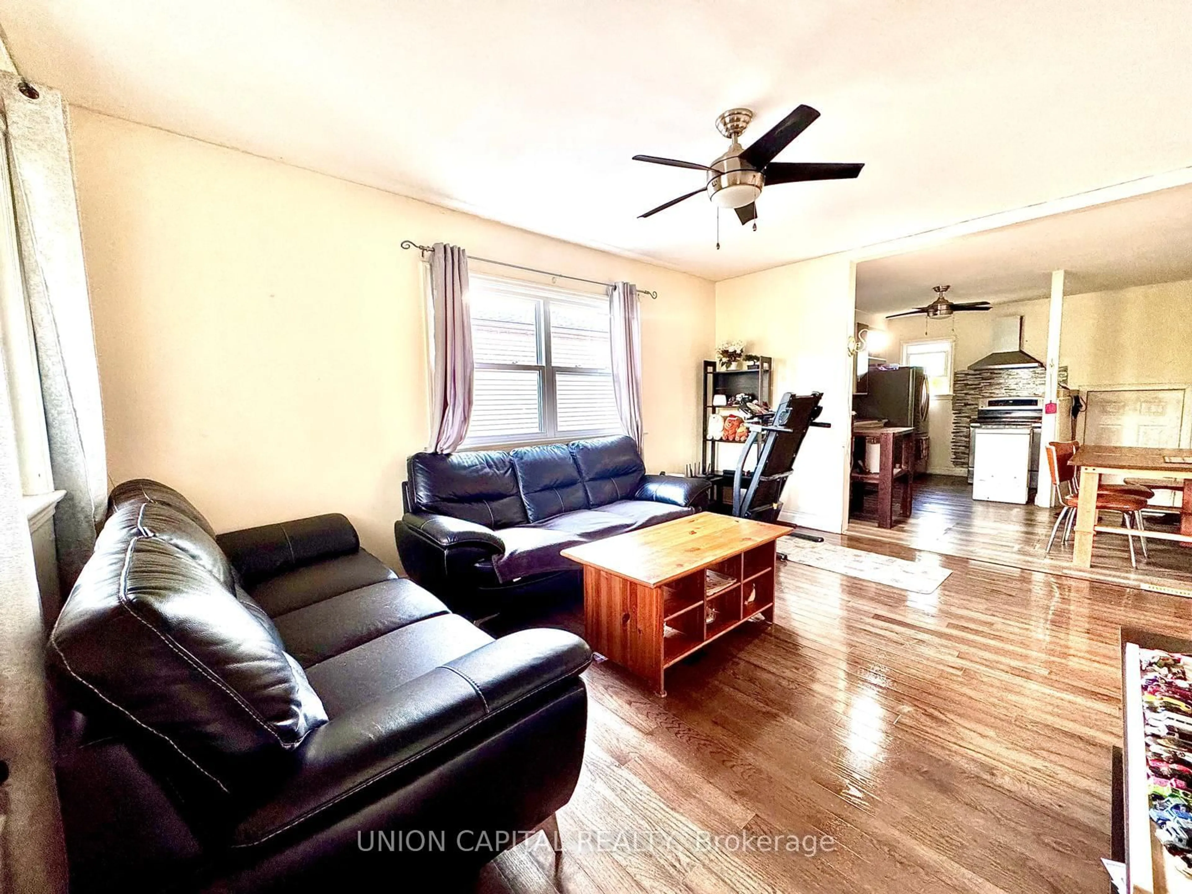 Living room with furniture, wood/laminate floor for 16 Cumming St, St. Catharines Ontario L2S 1H7