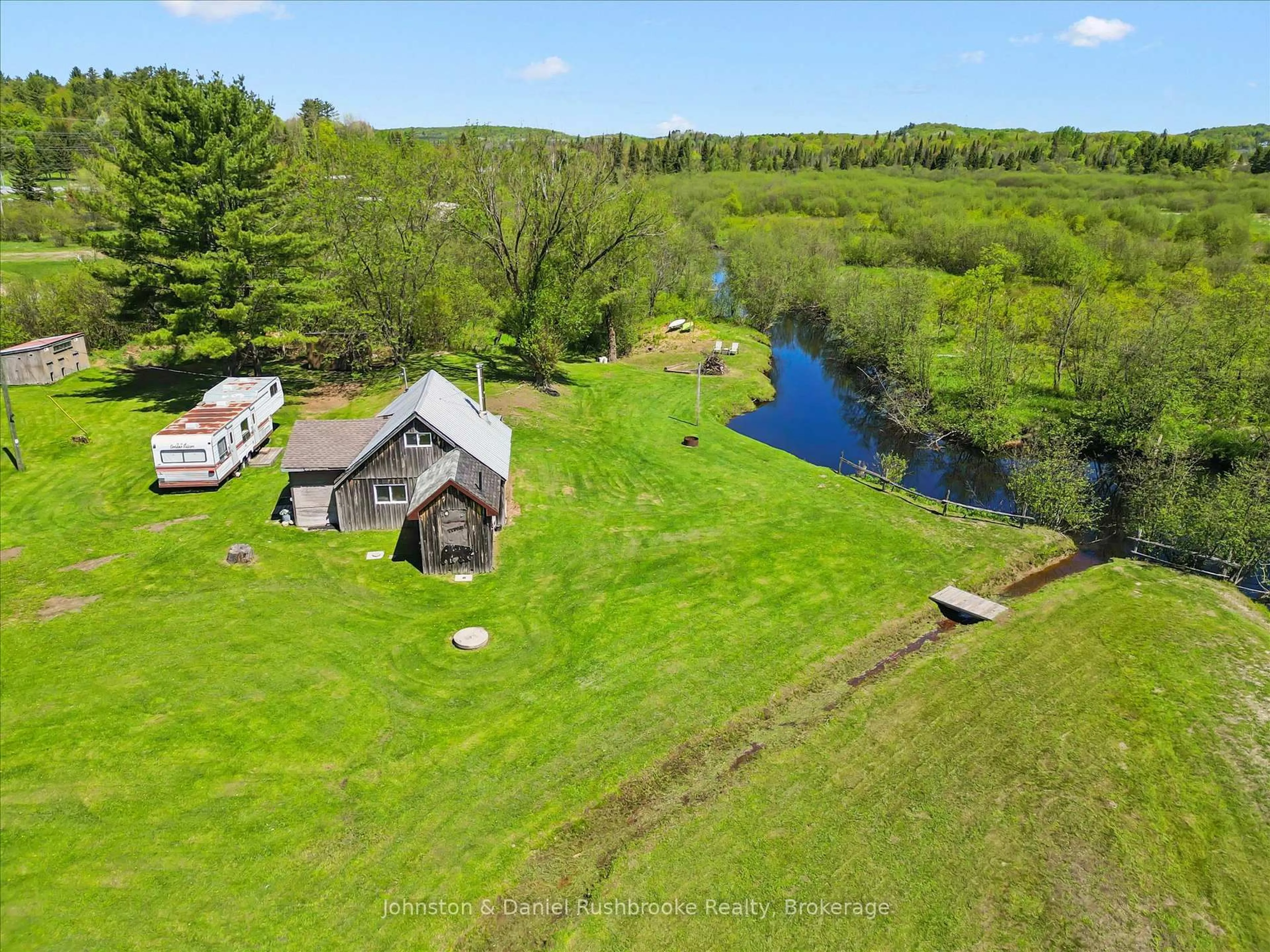 A pic from outside/outdoor area/front of a property/back of a property/a pic from drone, water/lake/river/ocean view for 68 Rowanwood Rd, Huntsville Ontario P0B 1M0