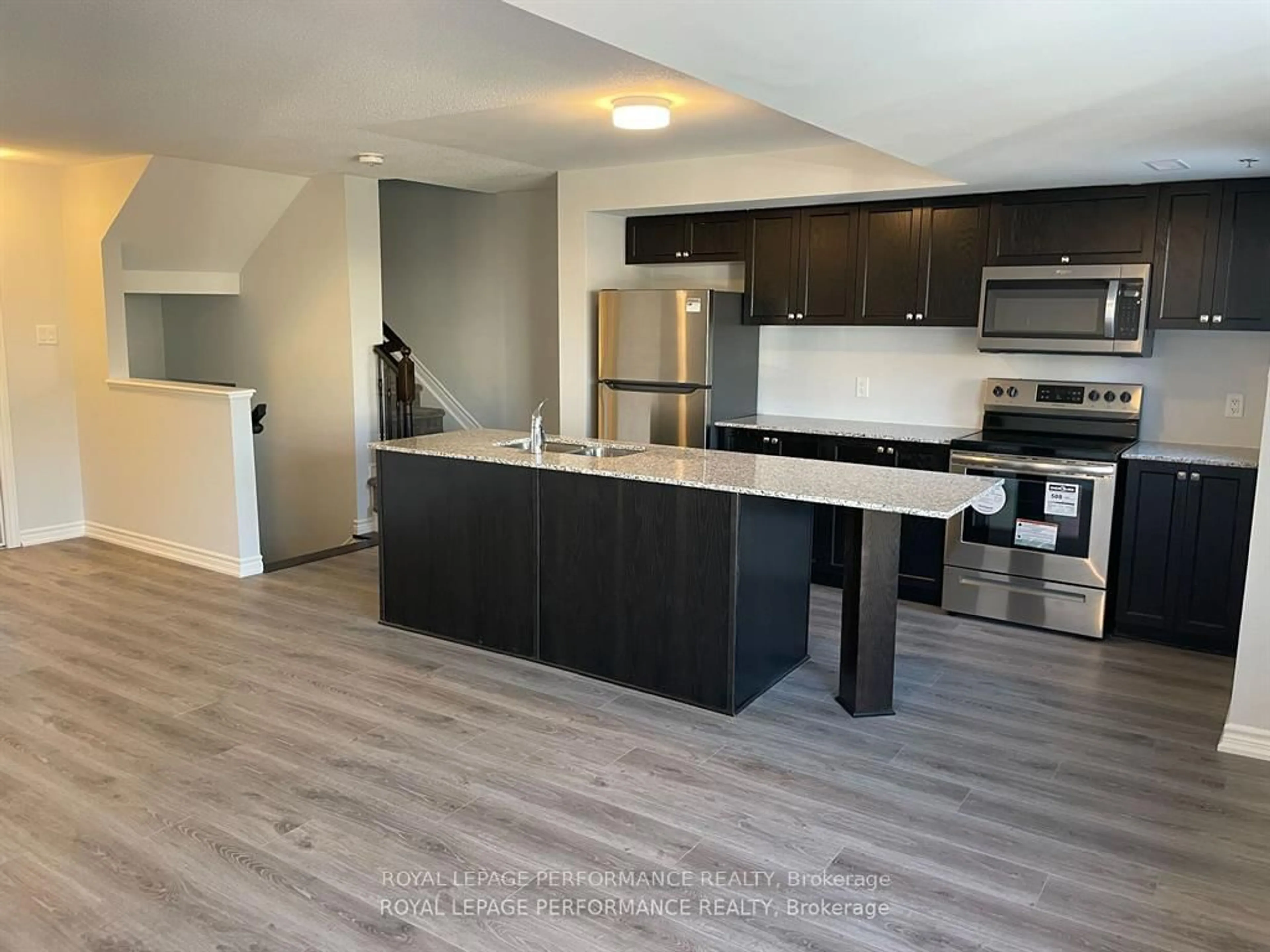 Open concept kitchen, wood/laminate floor for 704 Kizis Private, Ottawa Ontario K1K 5A4