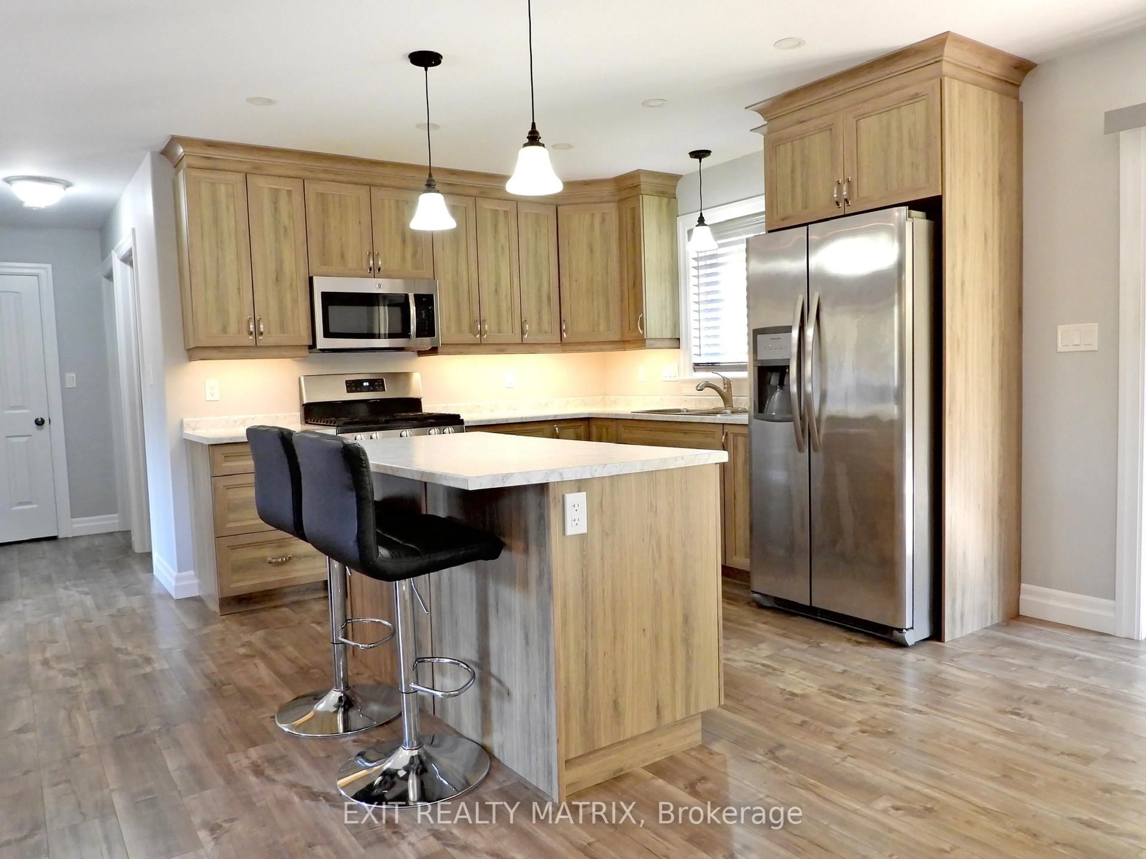 Open concept kitchen, wood/laminate floor for 1424 Bull Lake Rd, Arden Ontario K0H 1B0
