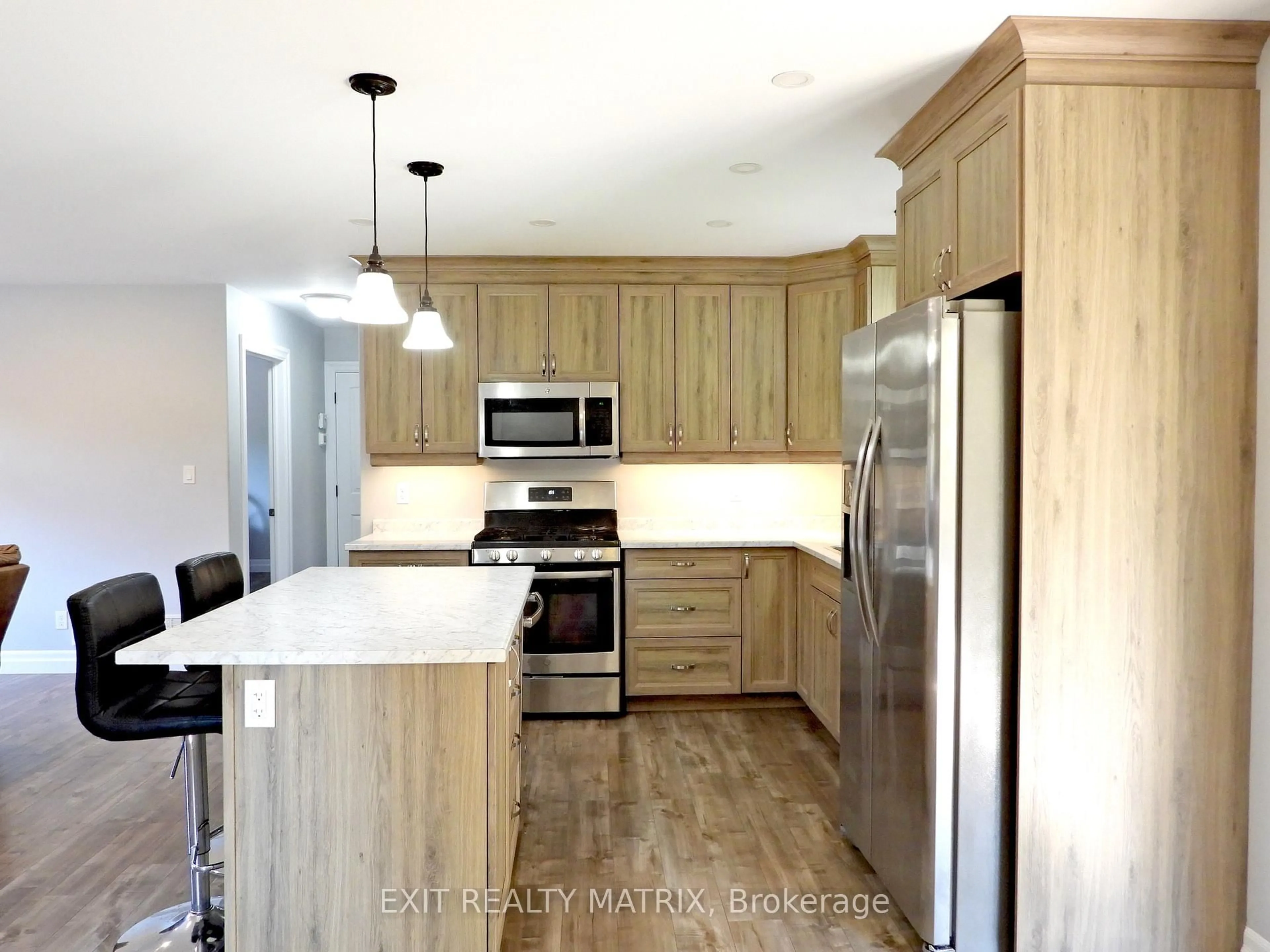Open concept kitchen, wood/laminate floor for 1424 Bull Lake Rd, Arden Ontario K0H 1B0