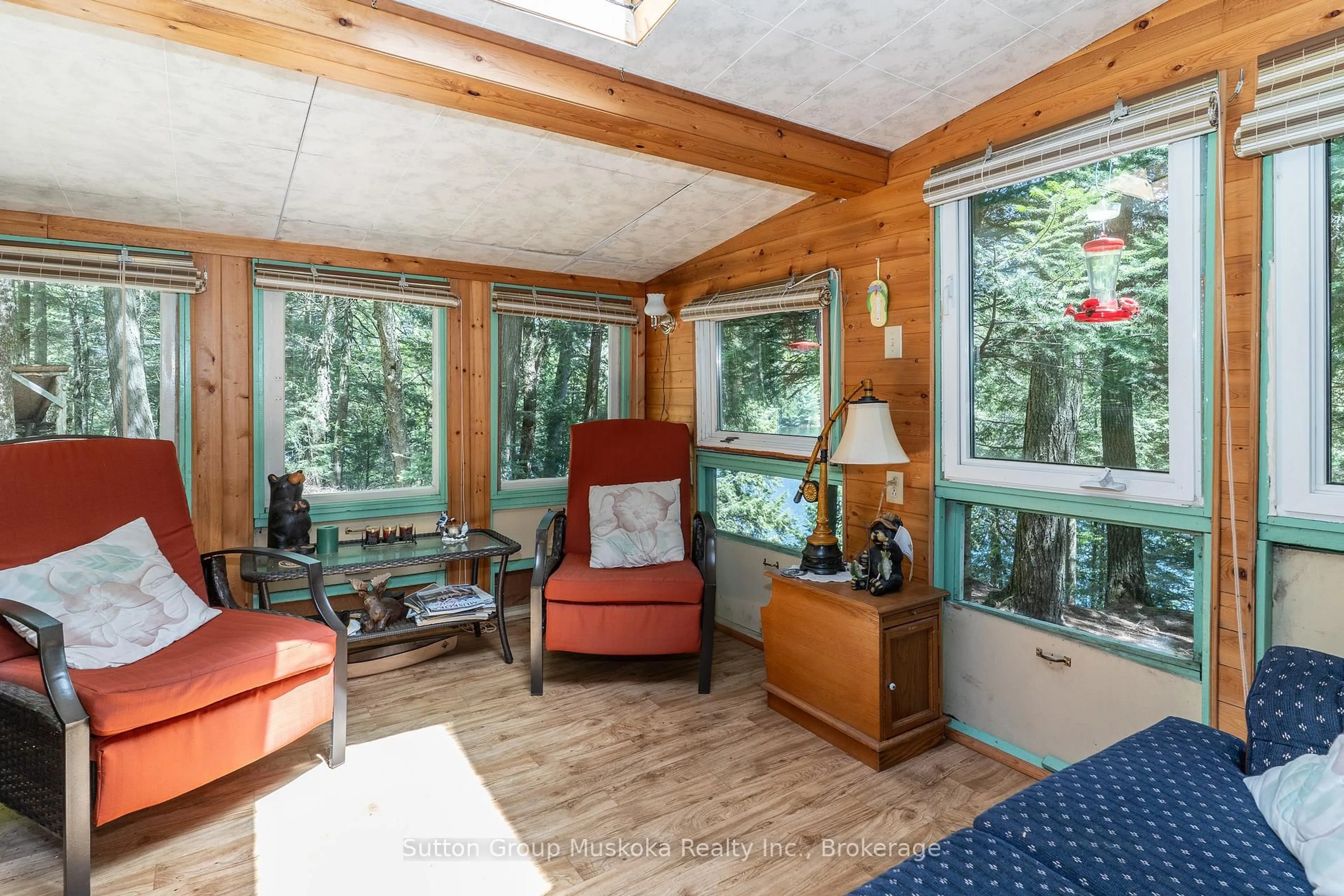 Living room with furniture, wood/laminate floor for 3149 Limberlost Rd, Lake of Bays Ontario P1H 2J6