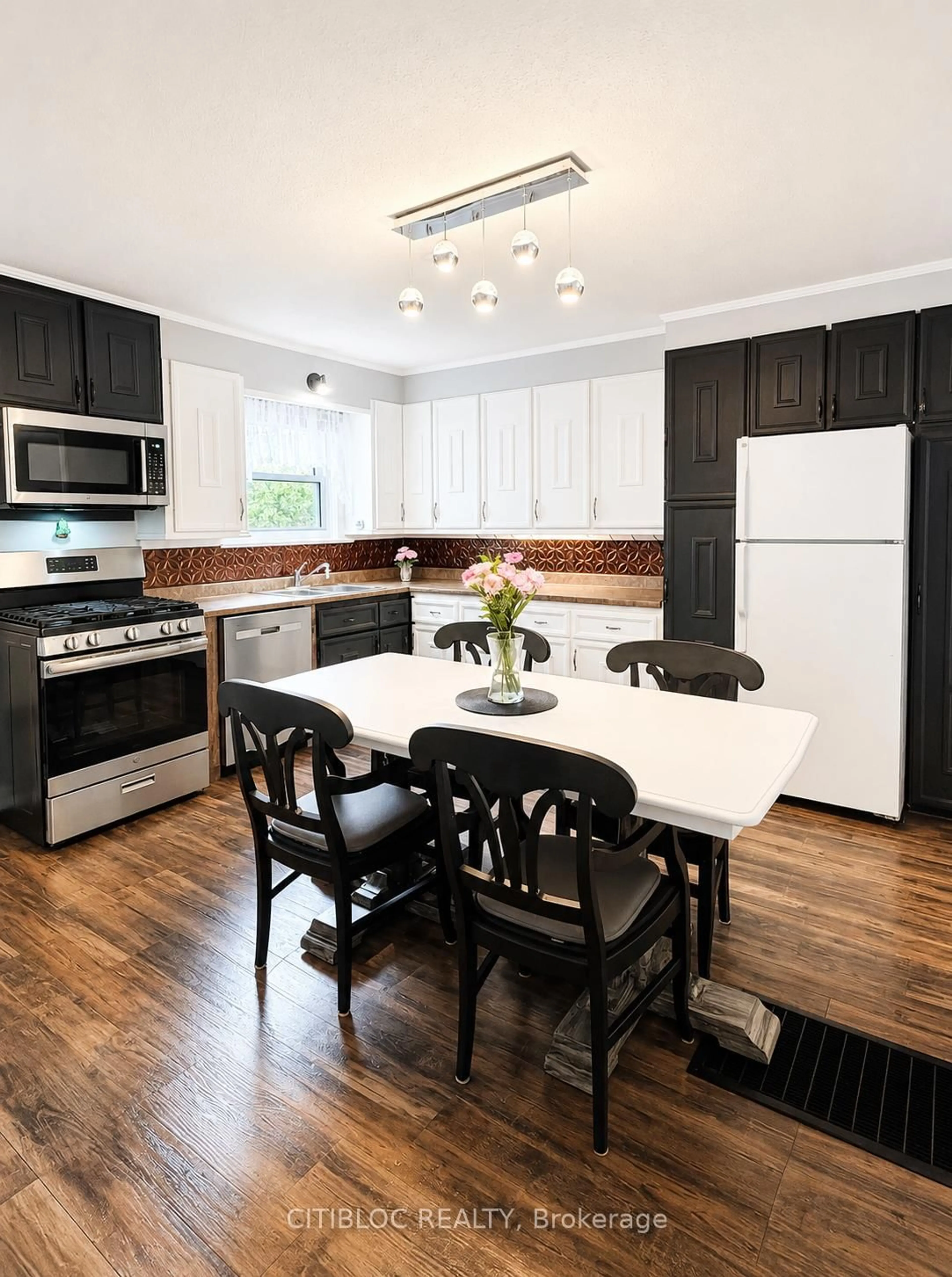 Open concept kitchen, wood/laminate floor for 67 Ottawa Ave, South River Ontario P0A 1X0