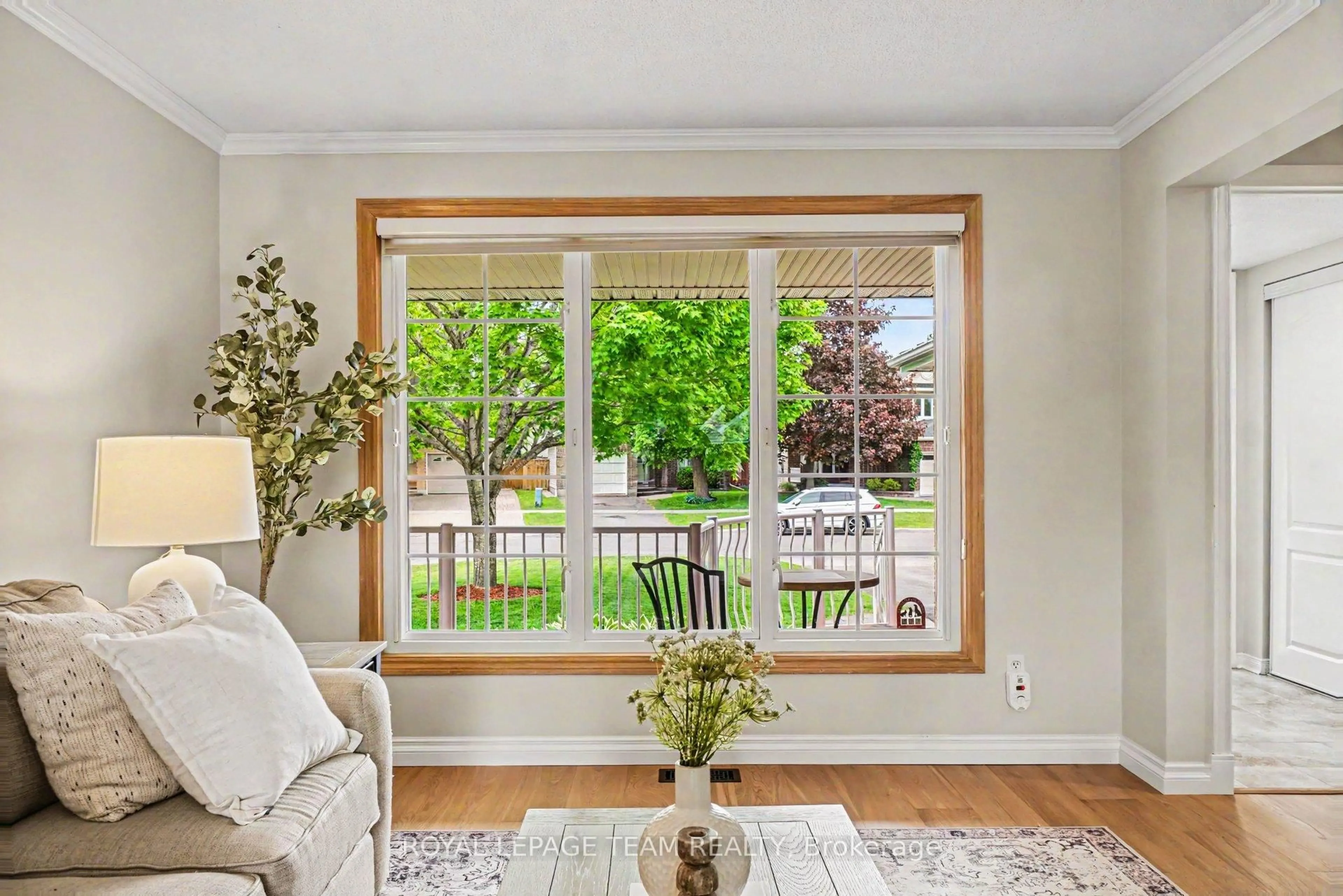 Living room with furniture, wood/laminate floor for 6114 Silverbirch St, Ottawa Ontario K1W 1C5