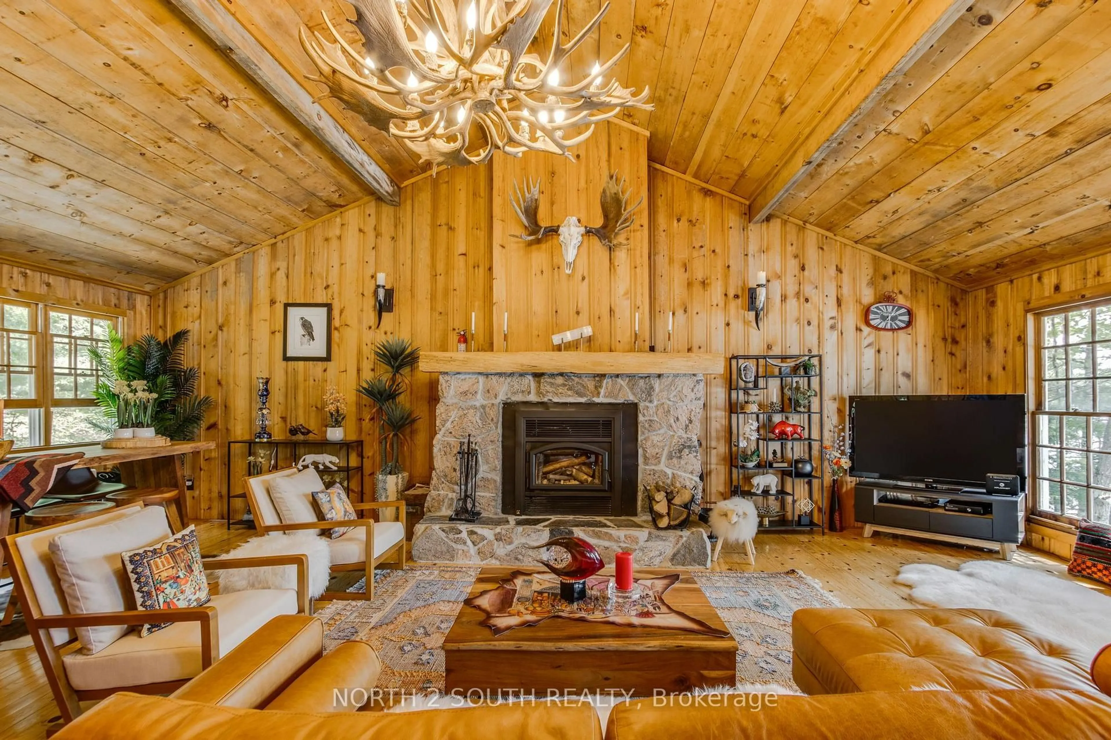 Living room with furniture, wood/laminate floor for 2133 Harrison Tr, Georgian Bay Ontario P0C 1H0