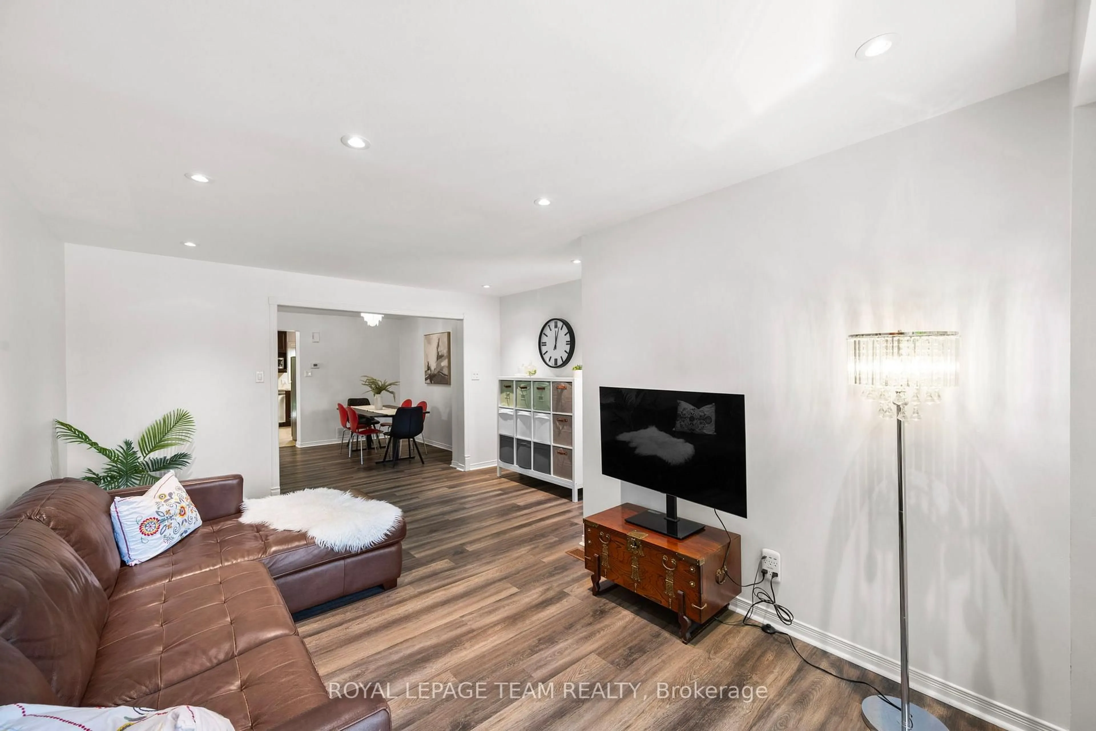 Living room with furniture, wood/laminate floor for 212 Provender Ave, Ottawa Ontario K1K 4N7