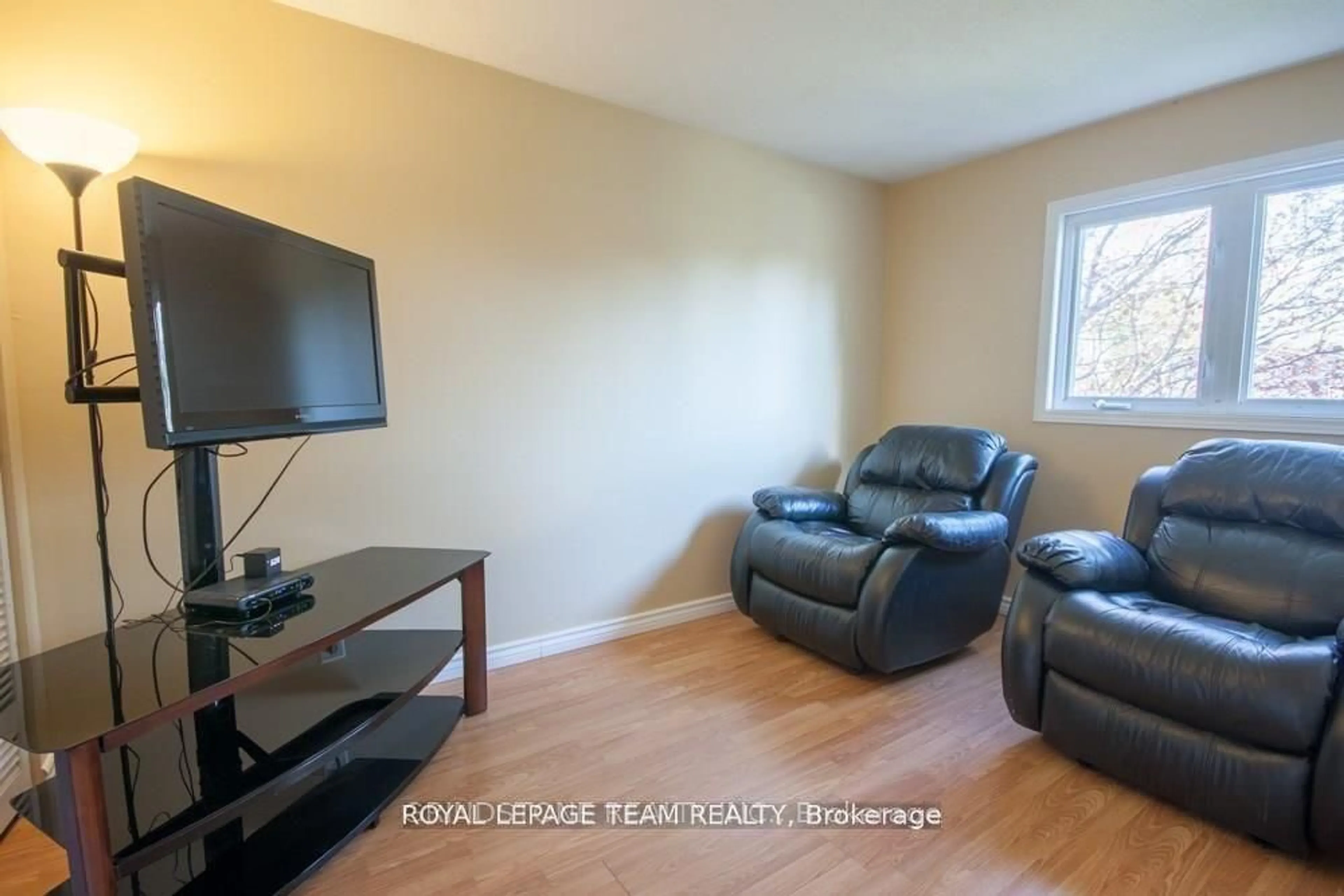 Living room with furniture, wood/laminate floor for 183 McElroy Dr, Kanata Ontario K2L 1X7