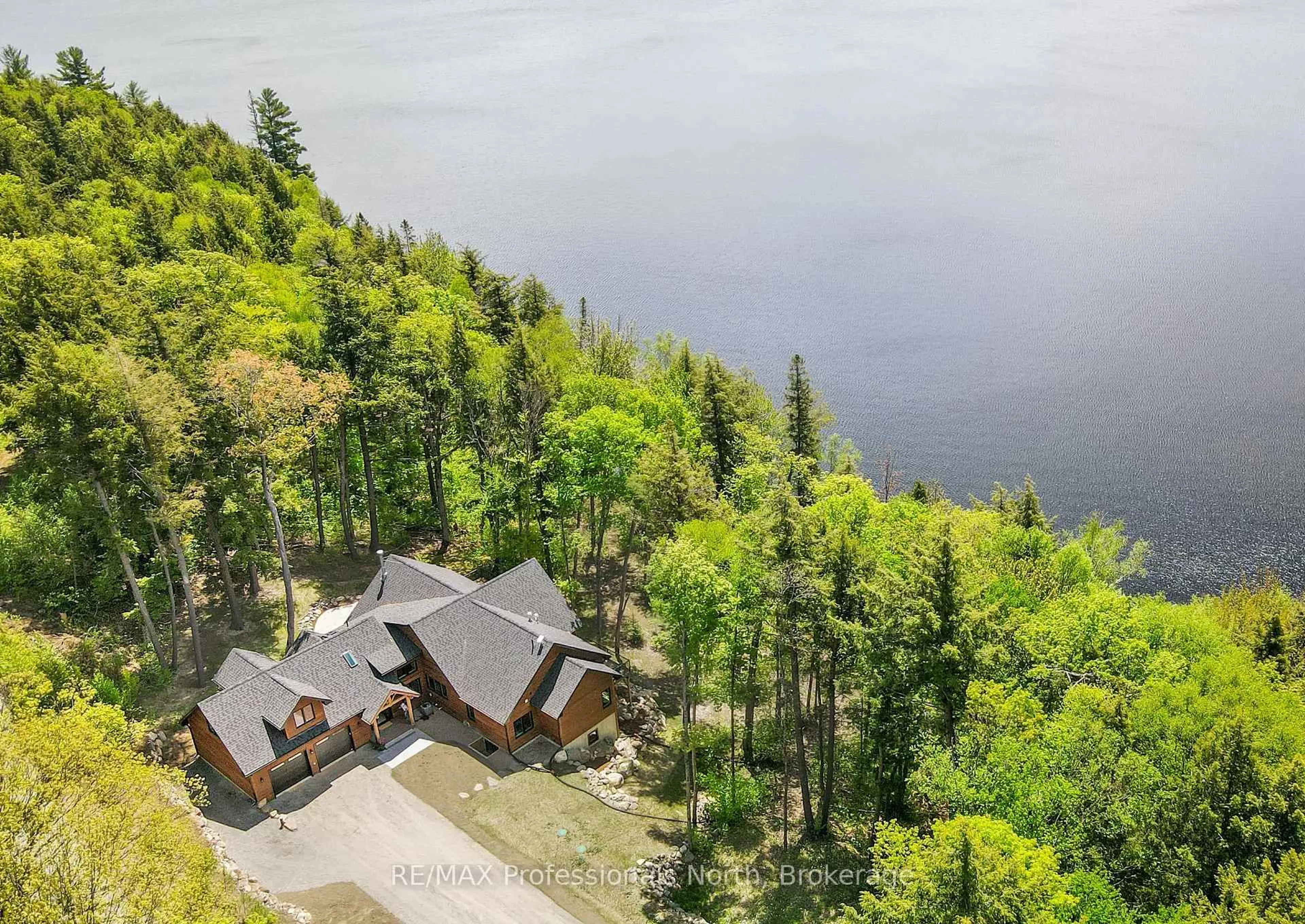 A pic from outside/outdoor area/front of a property/back of a property/a pic from drone, water/lake/river/ocean view for 1320 Flatwater Cove Tr, Dysart et al Ontario K0M 1S0