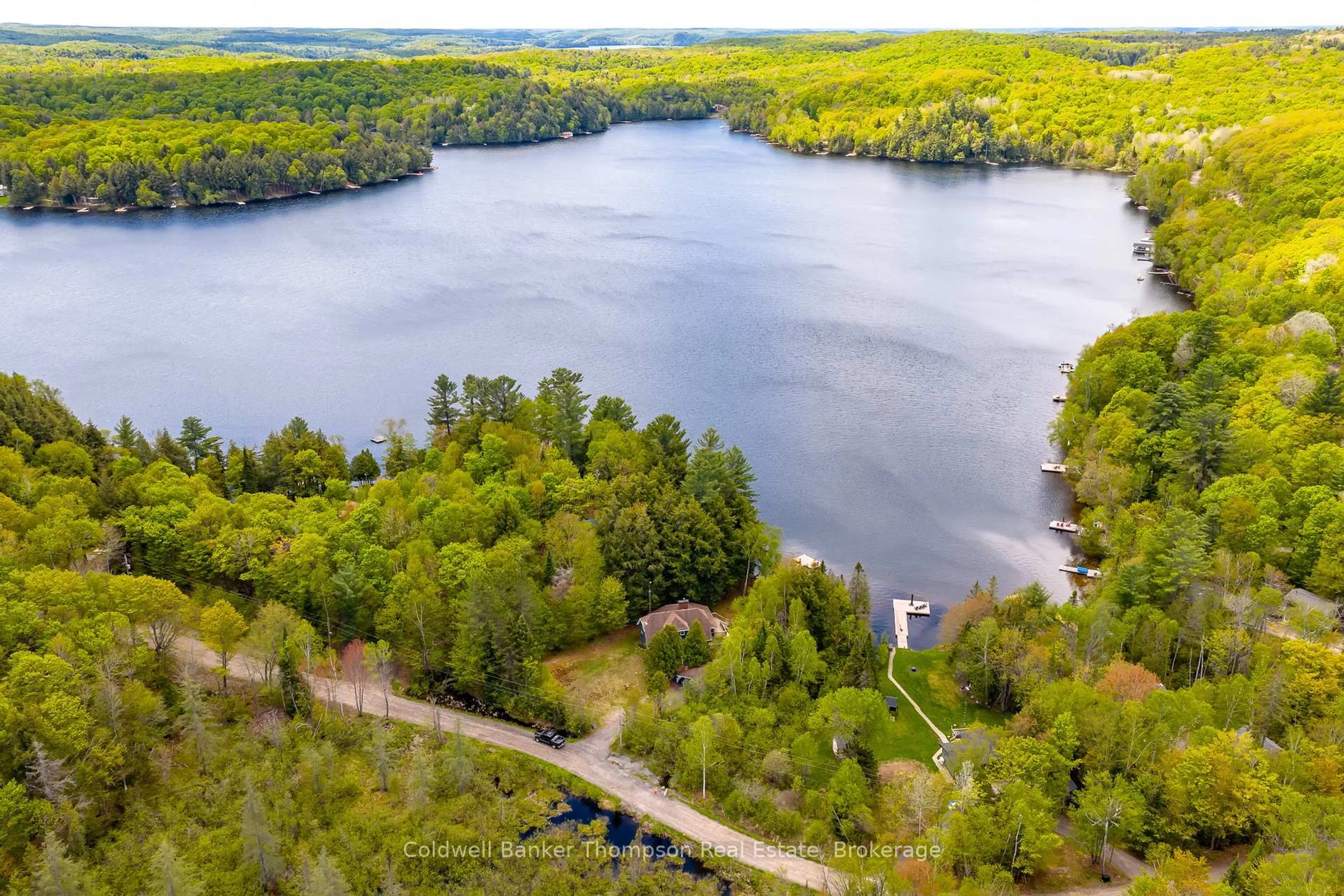A pic from outside/outdoor area/front of a property/back of a property/a pic from drone, water/lake/river/ocean view for 215 Ena Dr, Huntsville Ontario P1H 2J4