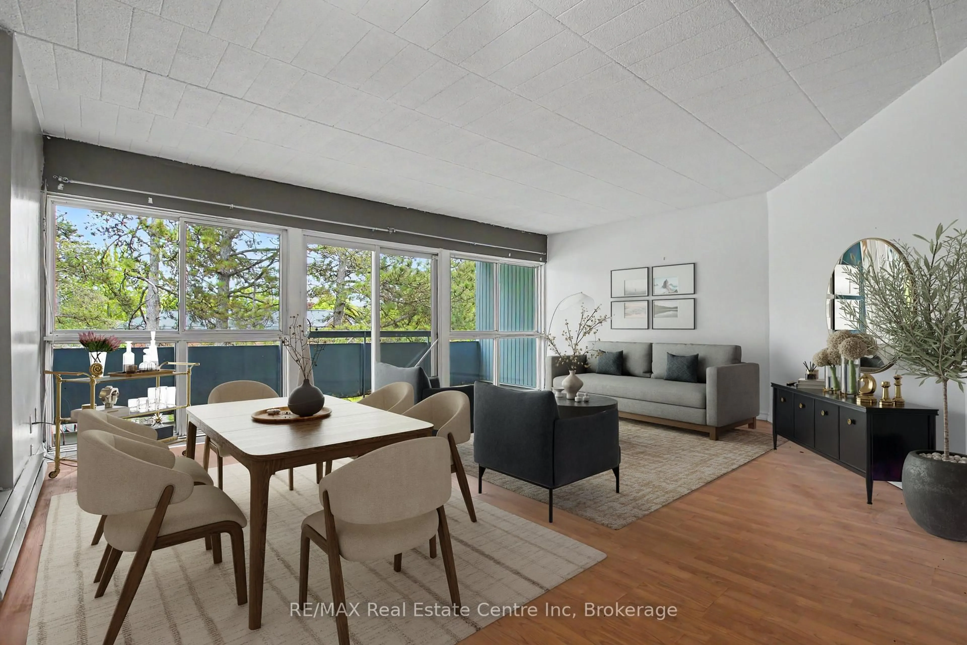 Living room with furniture, wood/laminate floor for 105 Conroy Cres #412, Guelph Ontario N1G 2V5