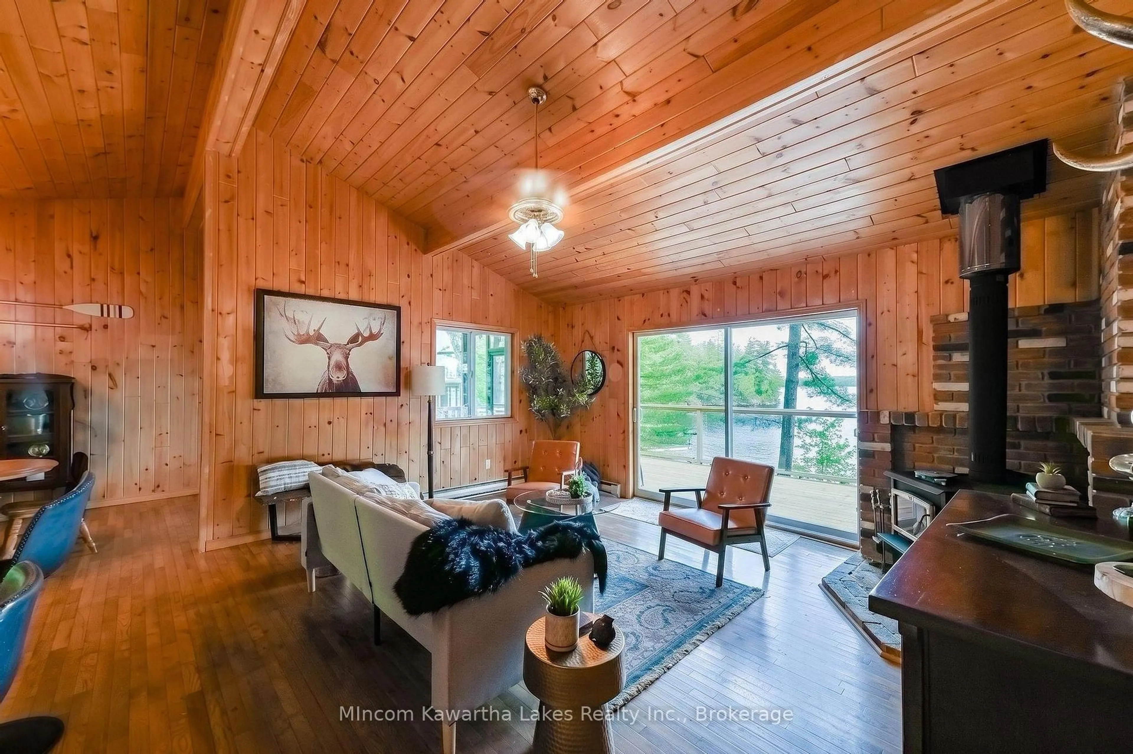 Living room with furniture, wood/laminate floor for 24 Fire Route 172, Trent Lakes Ontario K0L 1J0