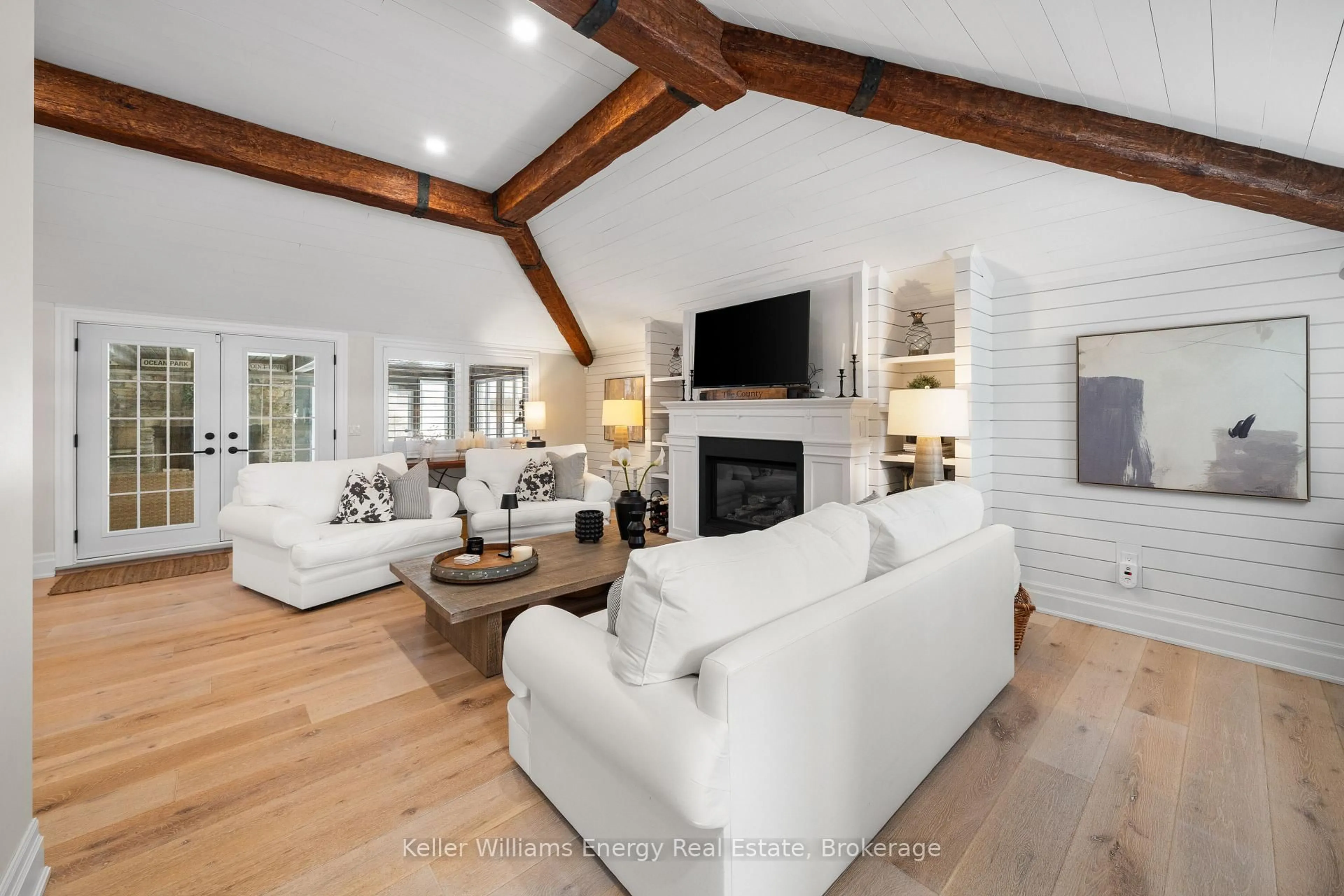 Living room with furniture, wood/laminate floor for 1245 Miller Rd, Prince Edward County Ontario K0K 2T0