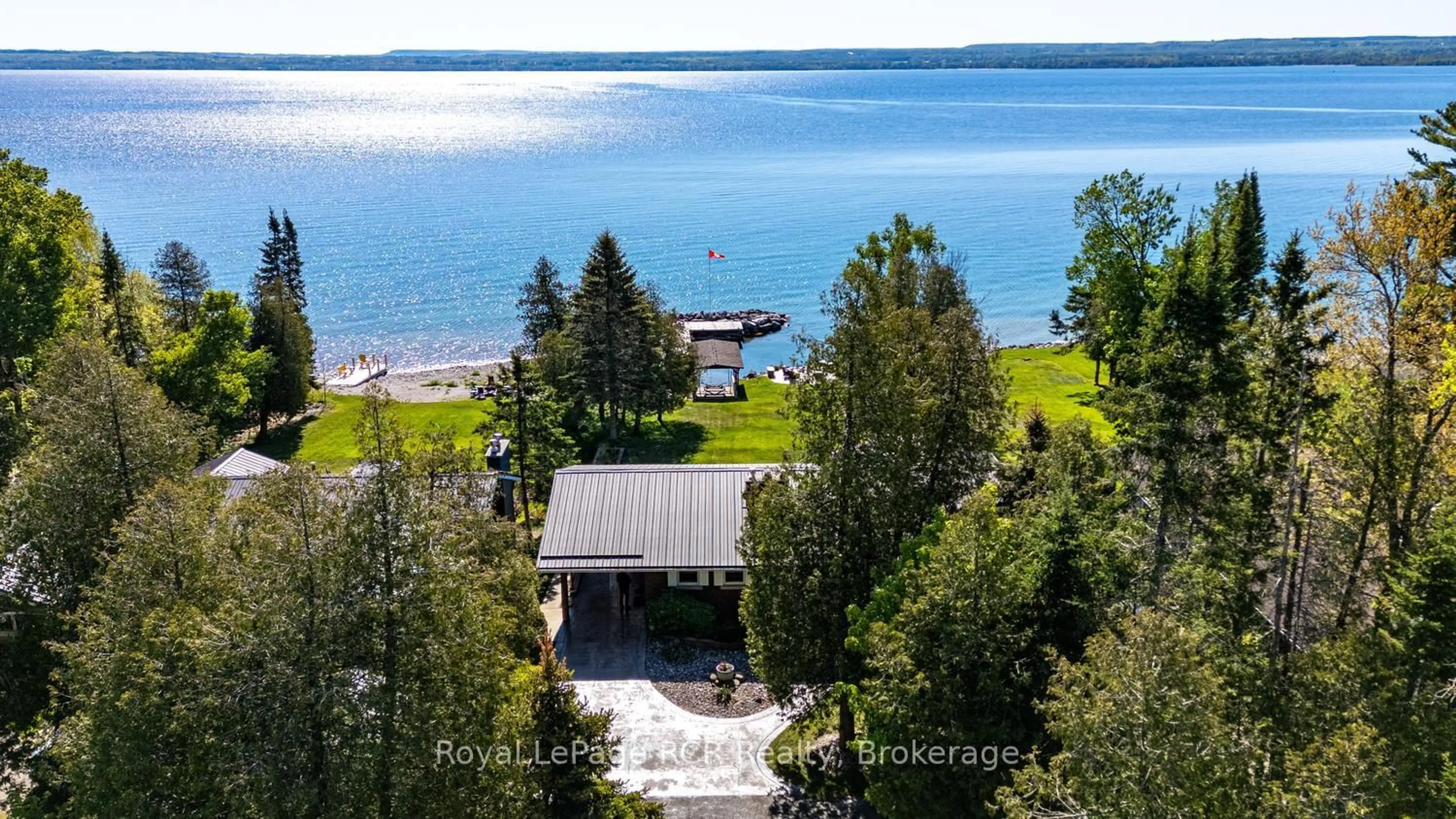 A pic from outside/outdoor area/front of a property/back of a property/a pic from drone, water/lake/river/ocean view for 405 Balmy Beach Rd, Georgian Bluffs Ontario N4K 5N4