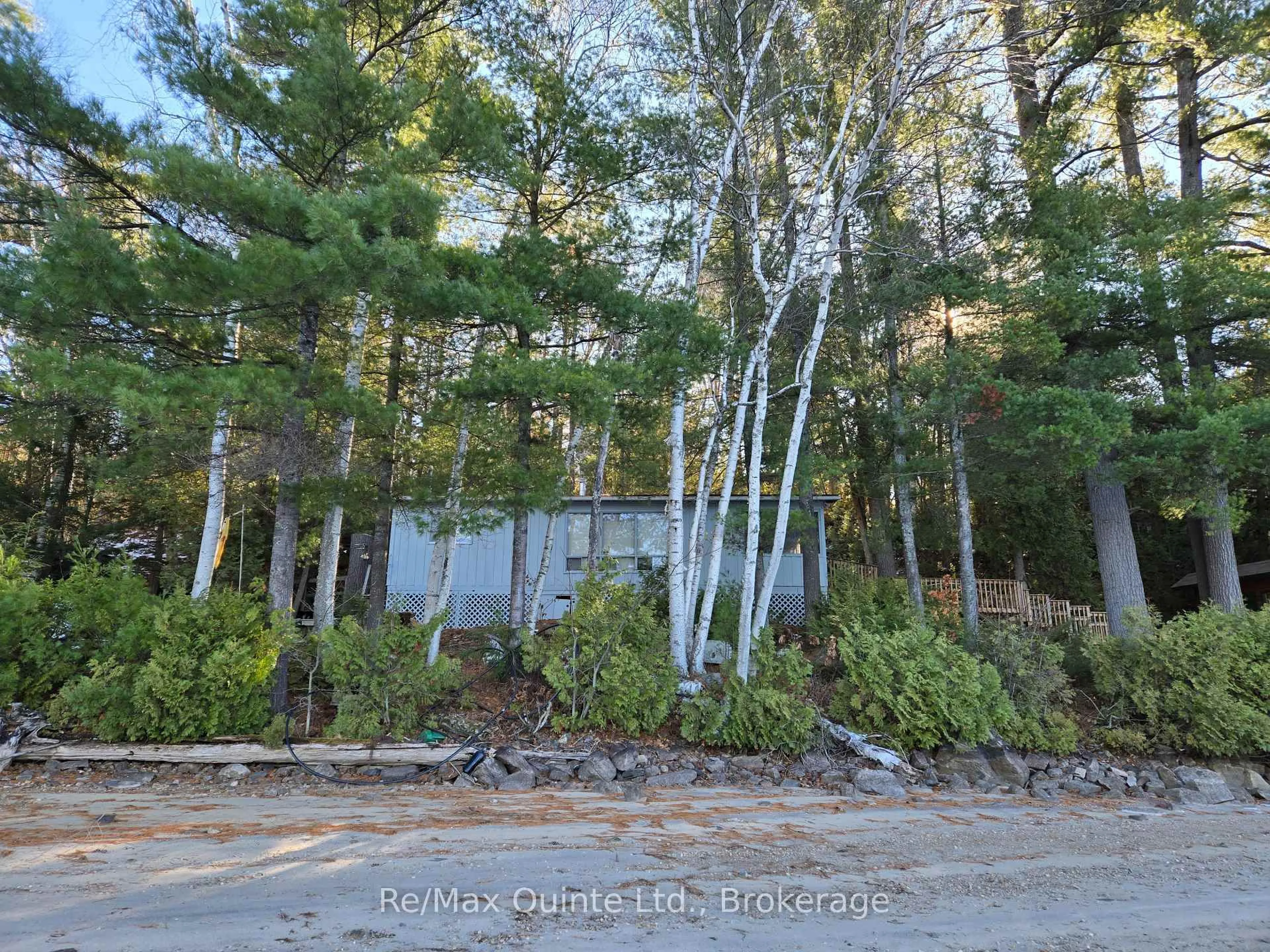 A pic from outside/outdoor area/front of a property/back of a property/a pic from drone, forest/trees view for 1261A Shawenegog Lake Lane, Cloyne Ontario K0H 1K0