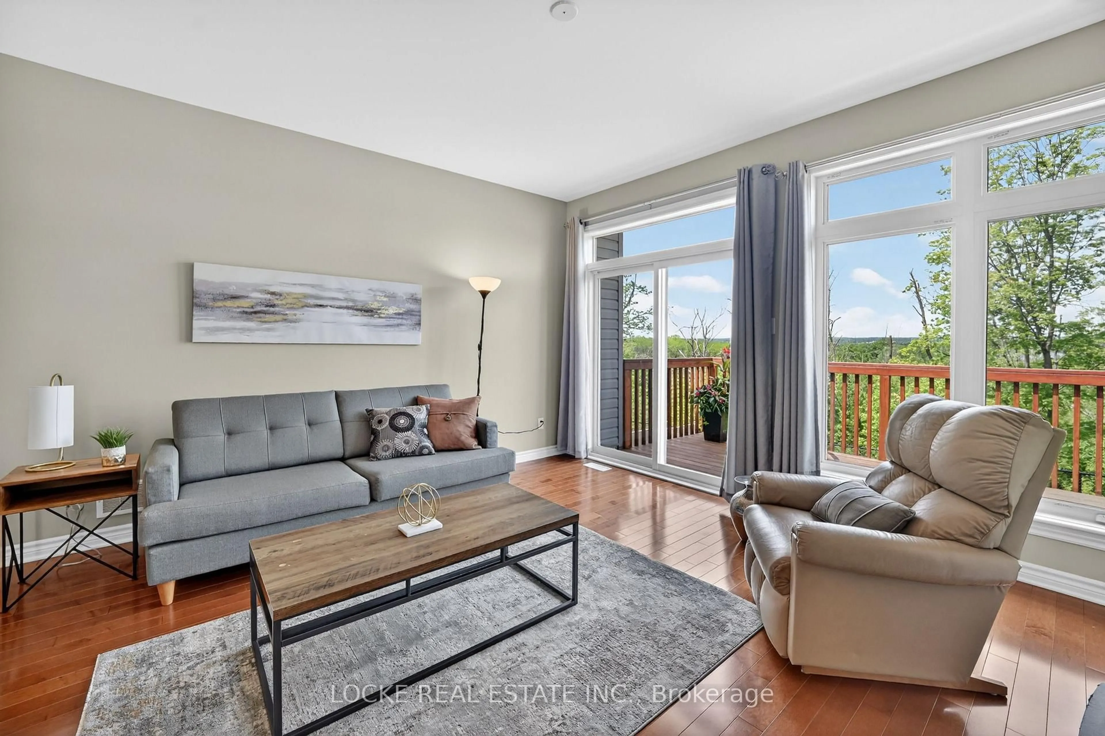 Living room with furniture, wood/laminate floor for 639 Baie-Des-Castors St, Orleans Ontario K4A 1J4