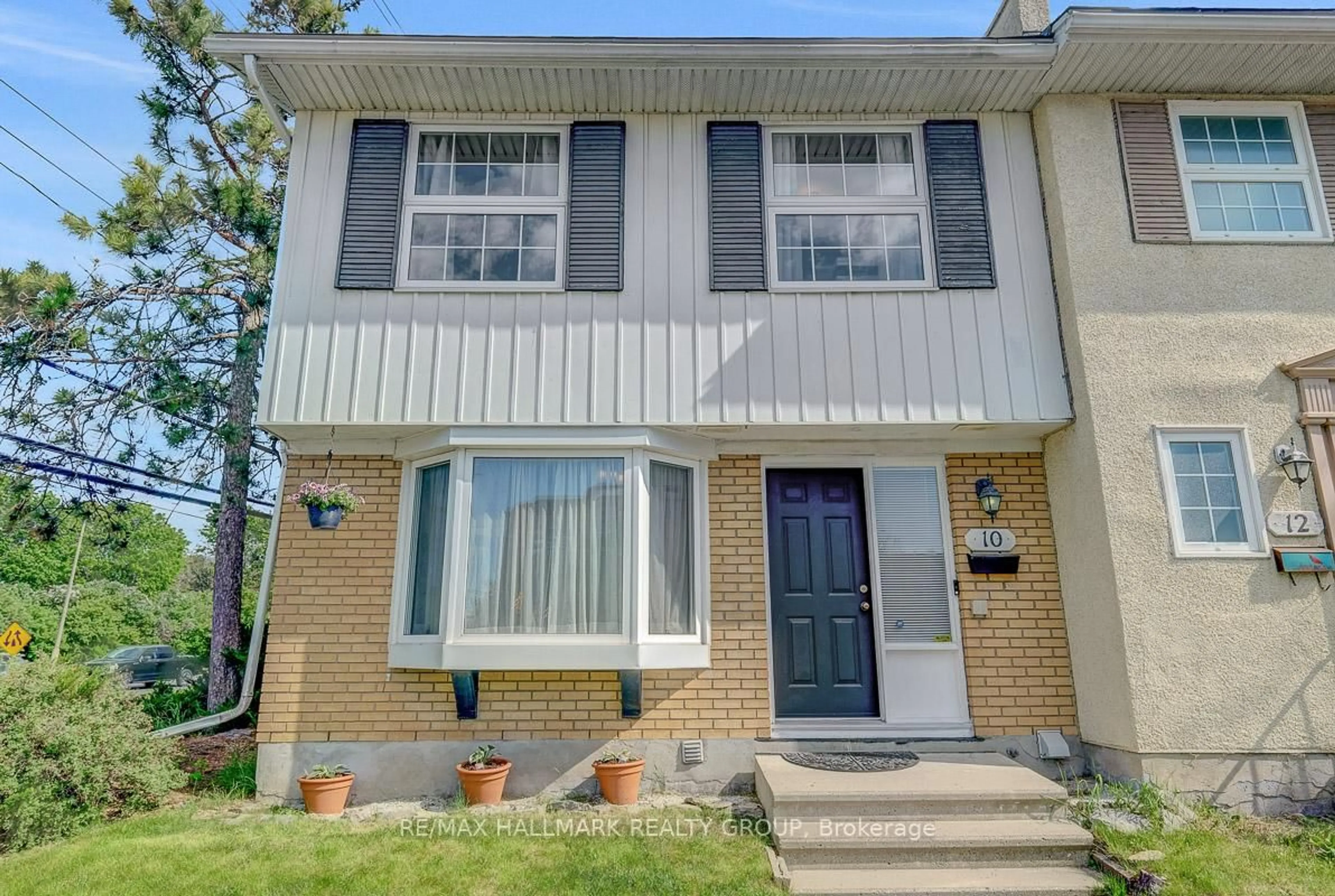 Home with vinyl exterior material, street for 10 Greenbank Rd, Ottawa Ontario K2H 5T9