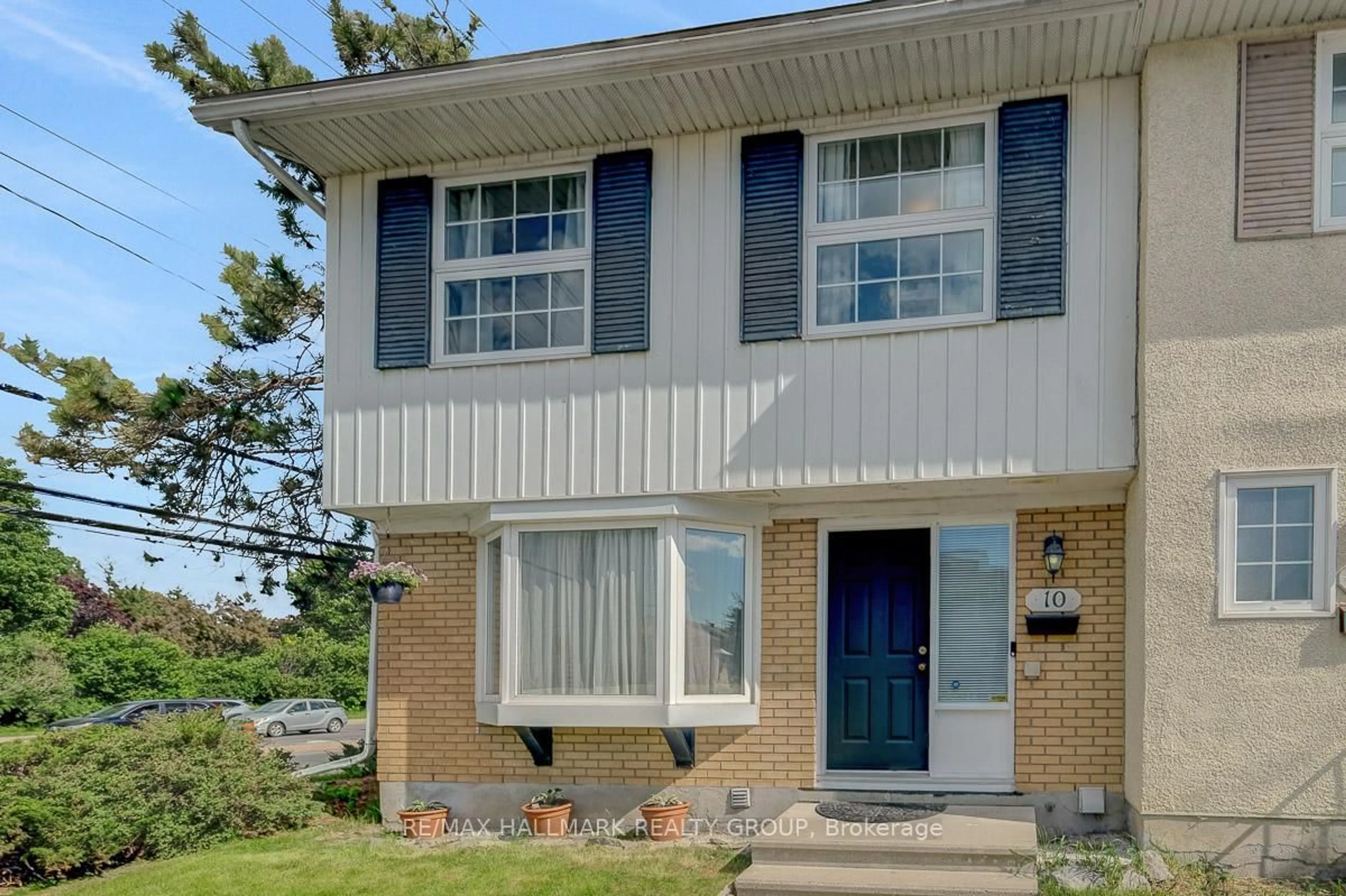 Home with vinyl exterior material, street for 10 Greenbank Rd, Ottawa Ontario K2H 5T9