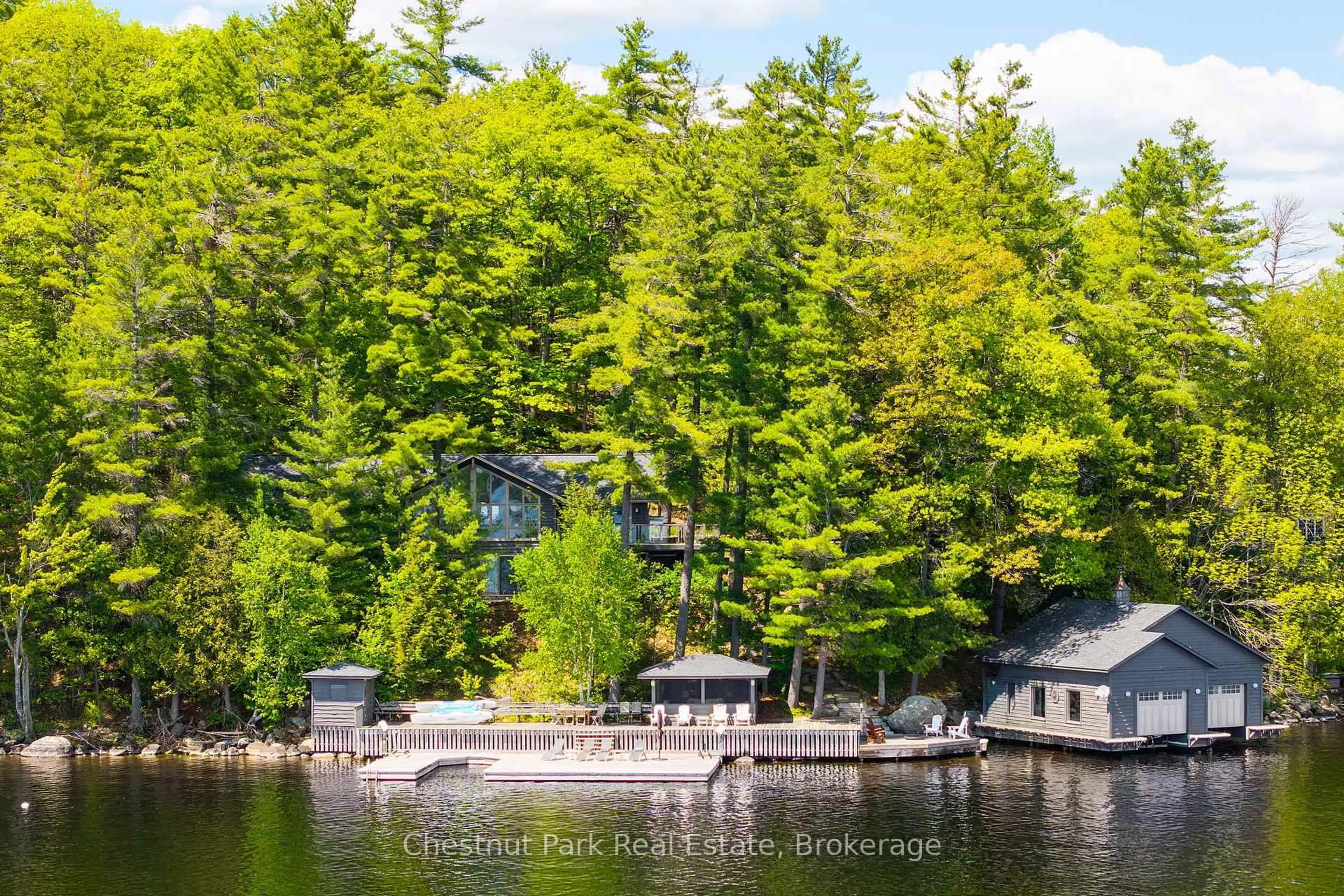 A pic from outside/outdoor area/front of a property/back of a property/a pic from drone, water/lake/river/ocean view for 1050 Trillium Dr, Bracebridge Ontario P1L 1X1
