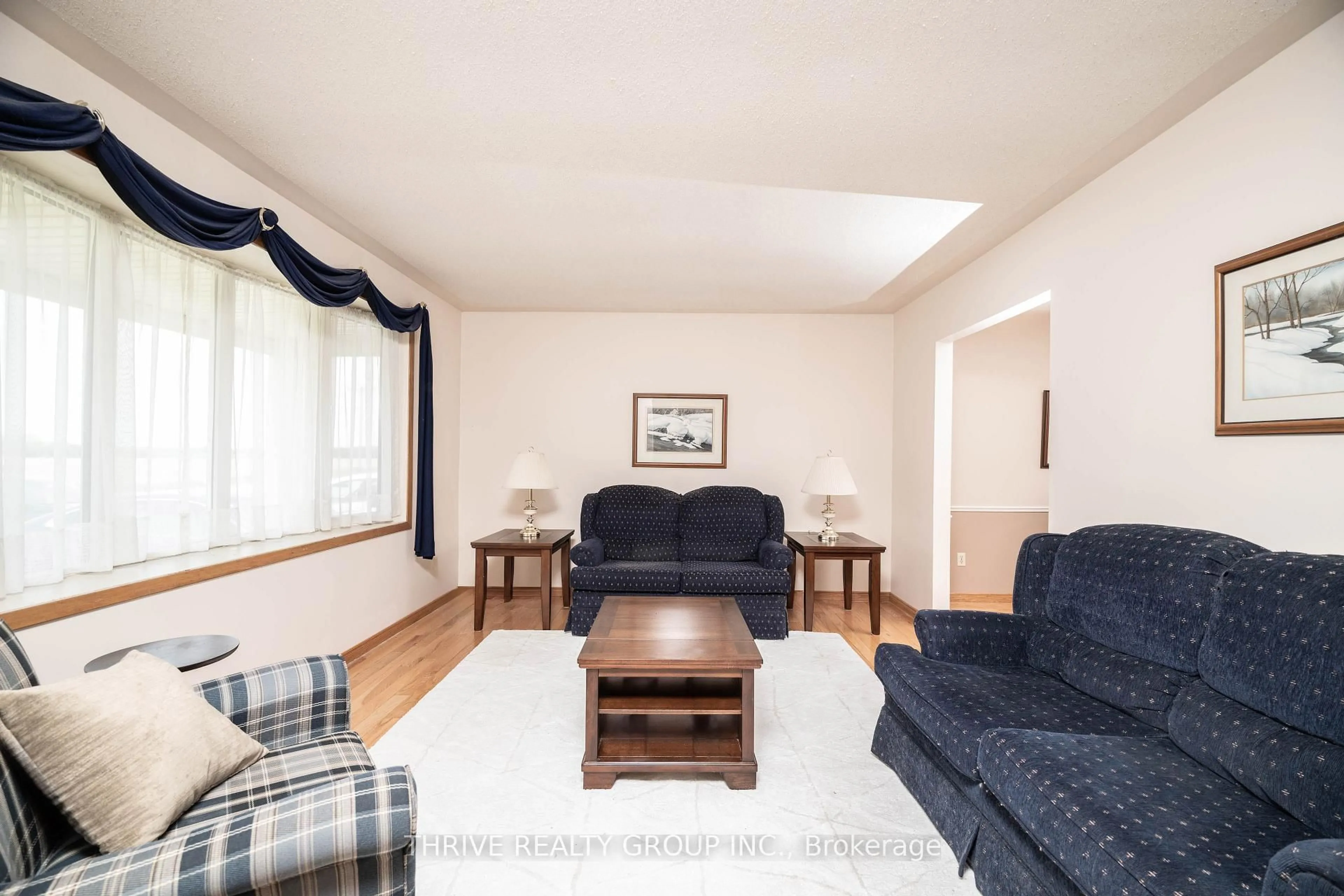 Living room with furniture, wood/laminate floor for 235 Stanley St, Zorra Ontario N0M 2M0