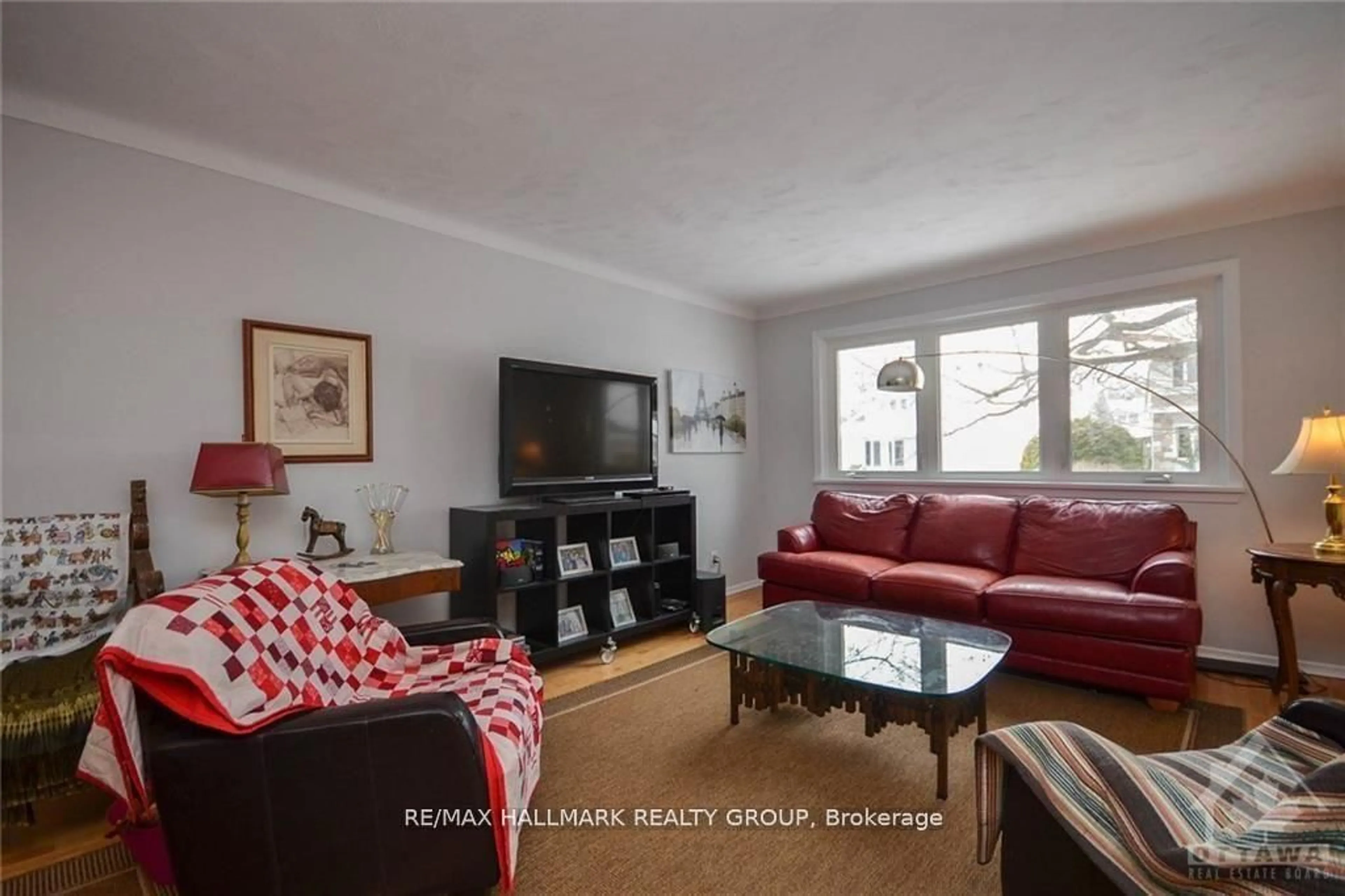 Living room with furniture, wood/laminate floor for 657 Golden Ave, Ottawa Ontario K2A 2G3