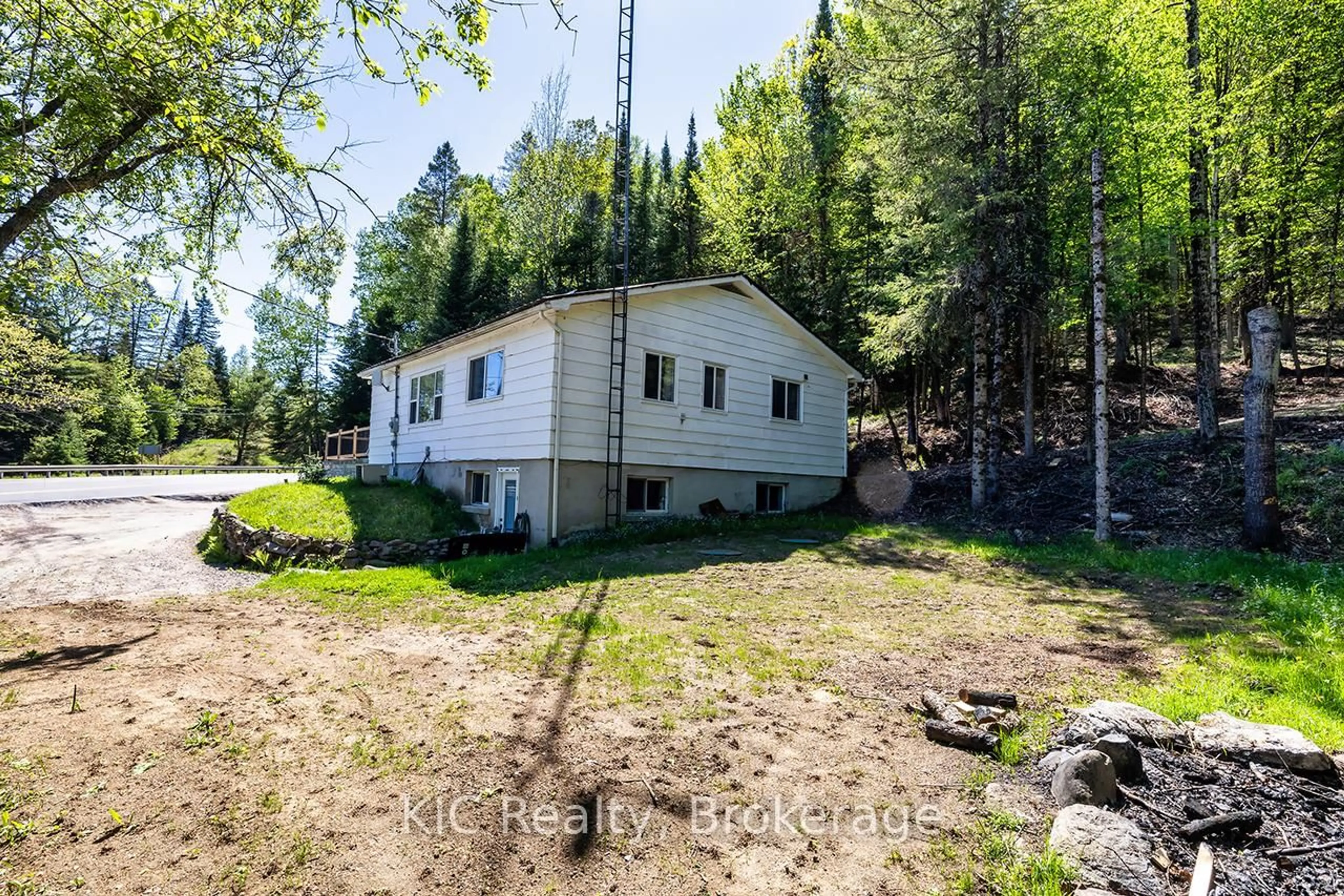 A pic from outside/outdoor area/front of a property/back of a property/a pic from drone, forest/trees view for 14202 Highway 118 Highway, Dysart et al Ontario K0M 1S0
