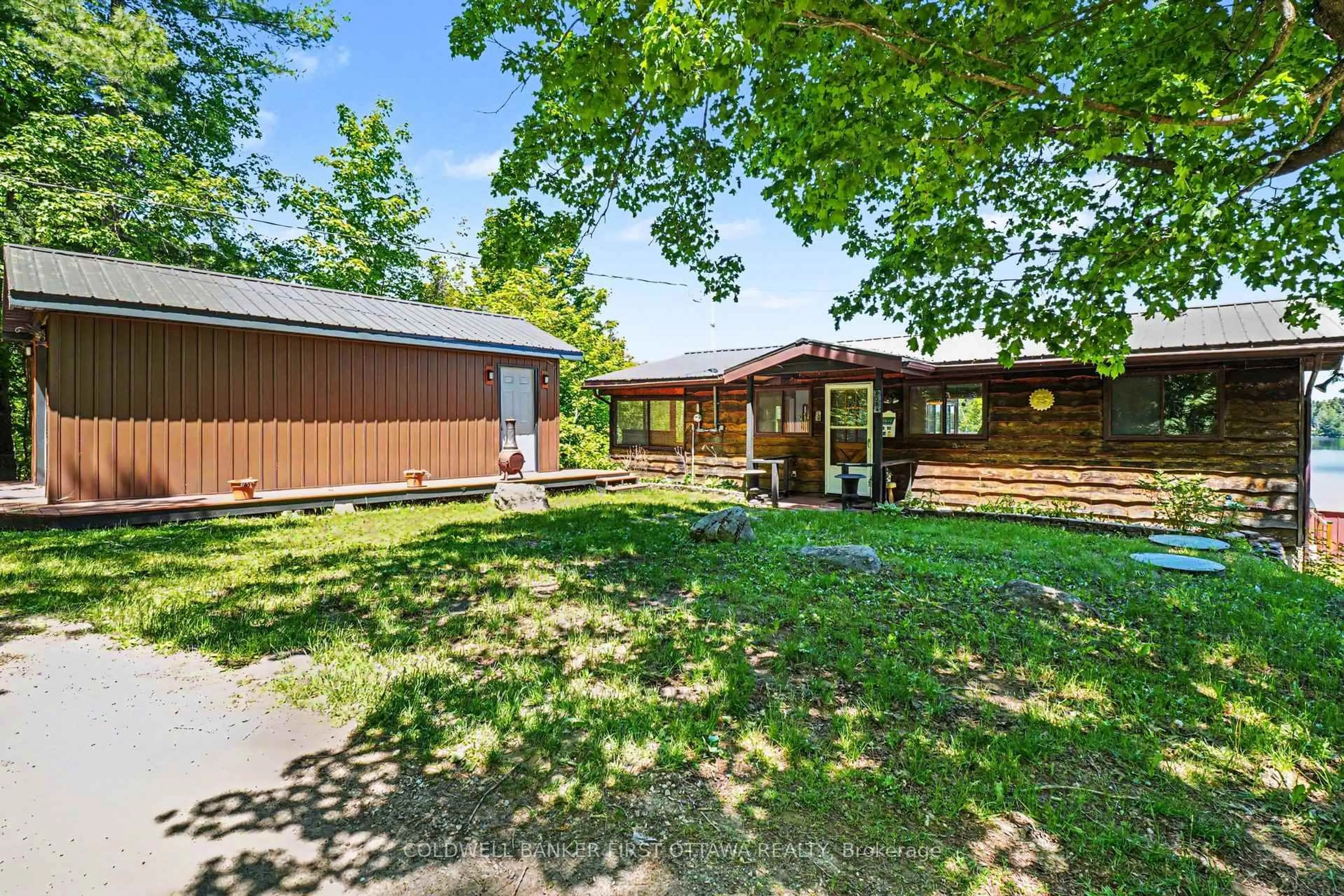 A pic from outside/outdoor area/front of a property/back of a property/a pic from drone, street for 1394 Black Lake North Shore, Perth Ontario K7H 3C5