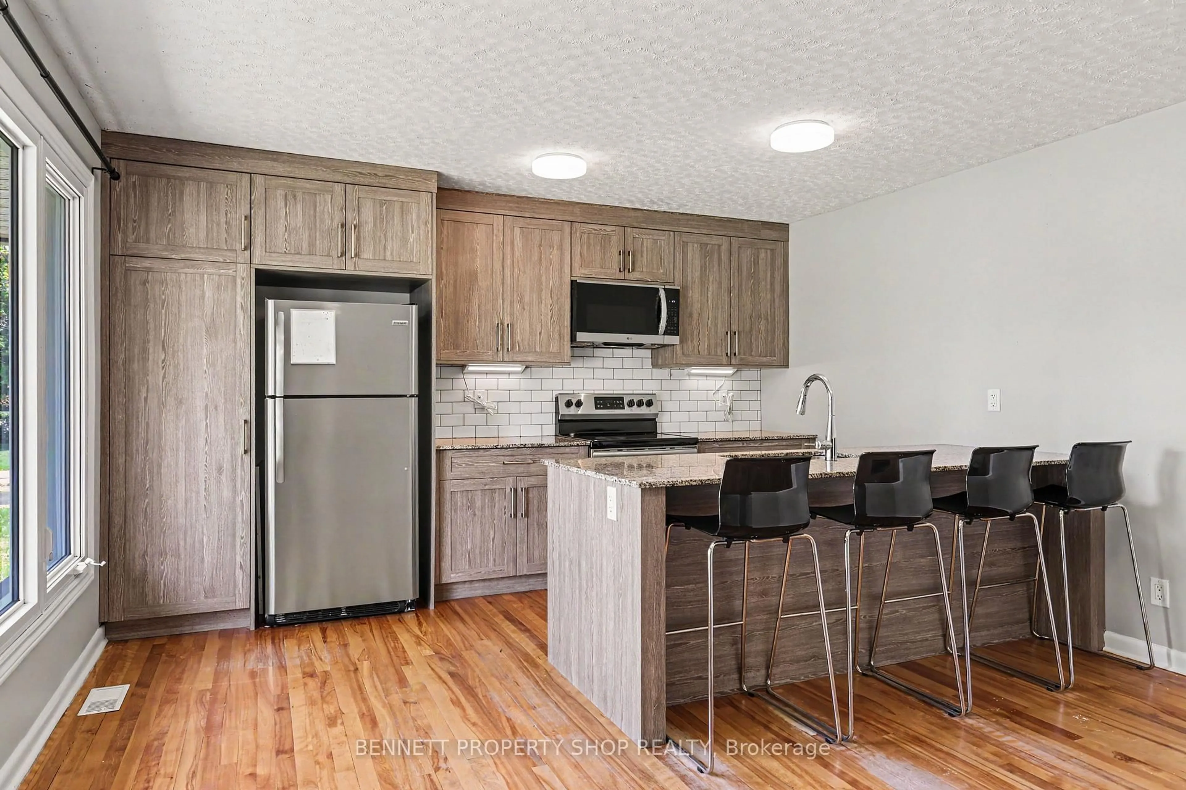Open concept kitchen, wood/laminate floor for 1308 Rustic Dr, Ottawa Ontario K2C 2Y1