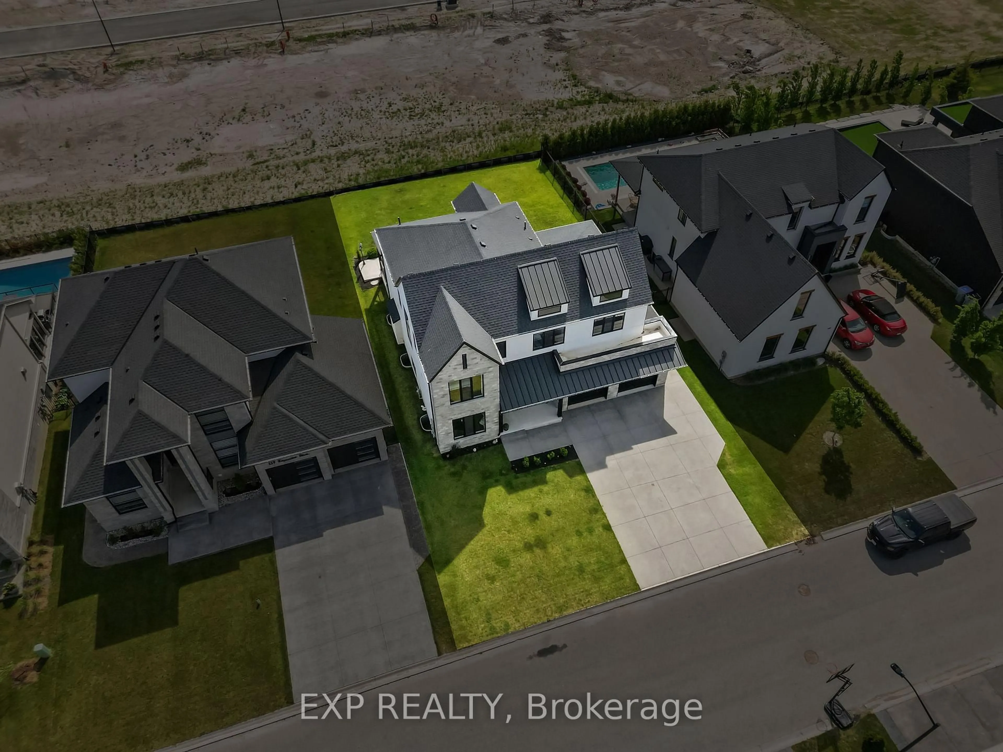 A pic from outside/outdoor area/front of a property/back of a property/a pic from drone, street for 113 Edgewater Blvd, Middlesex Centre Ontario N0L 1R0