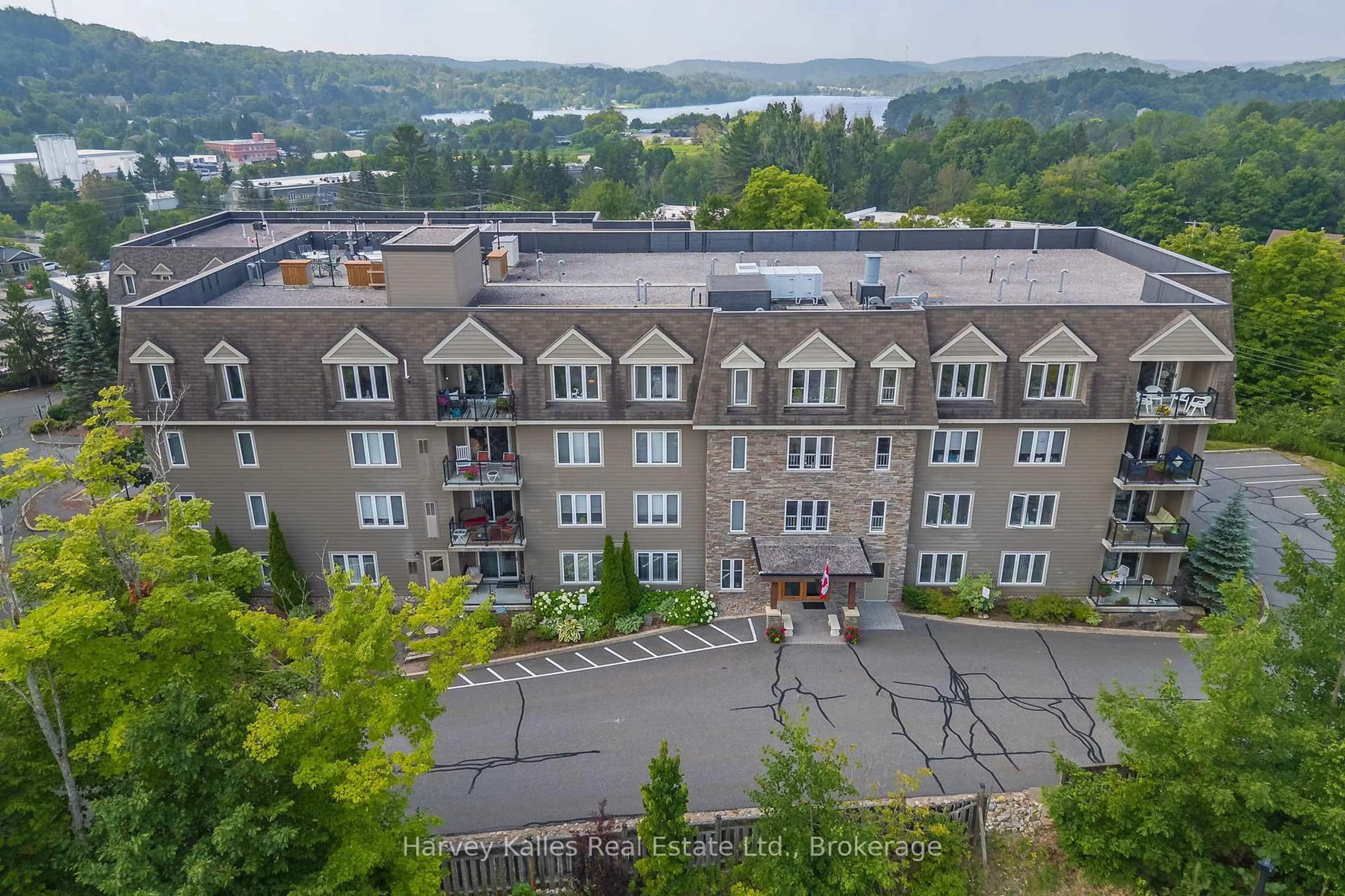 A pic from outside/outdoor area/front of a property/back of a property/a pic from drone, unknown for 26 Dairy Lane #205, Huntsville Ontario P1H 0A4