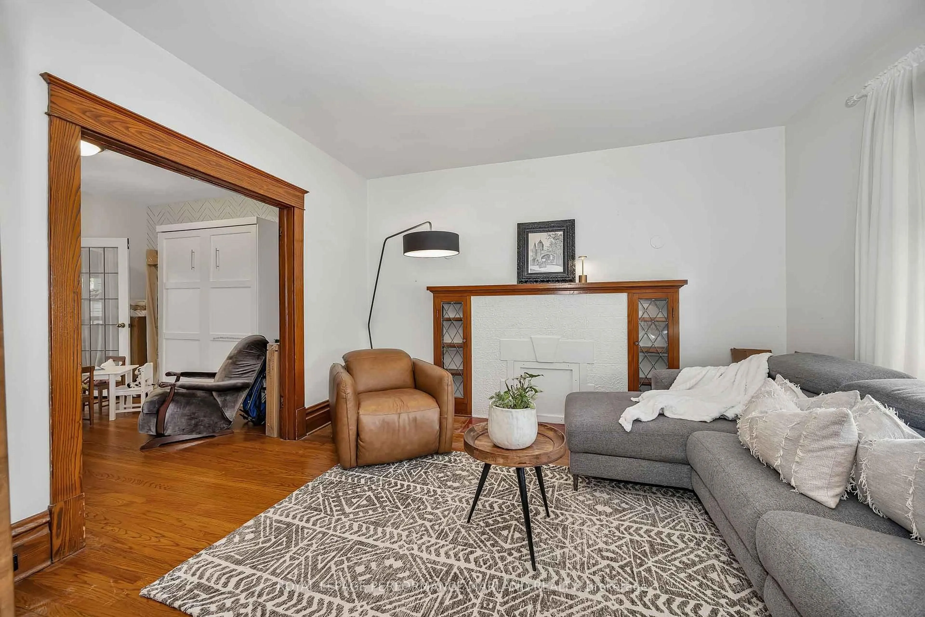 Living room with furniture, wood/laminate floor for 118 Aylmer Ave, Ottawa Ontario K1S 2X9