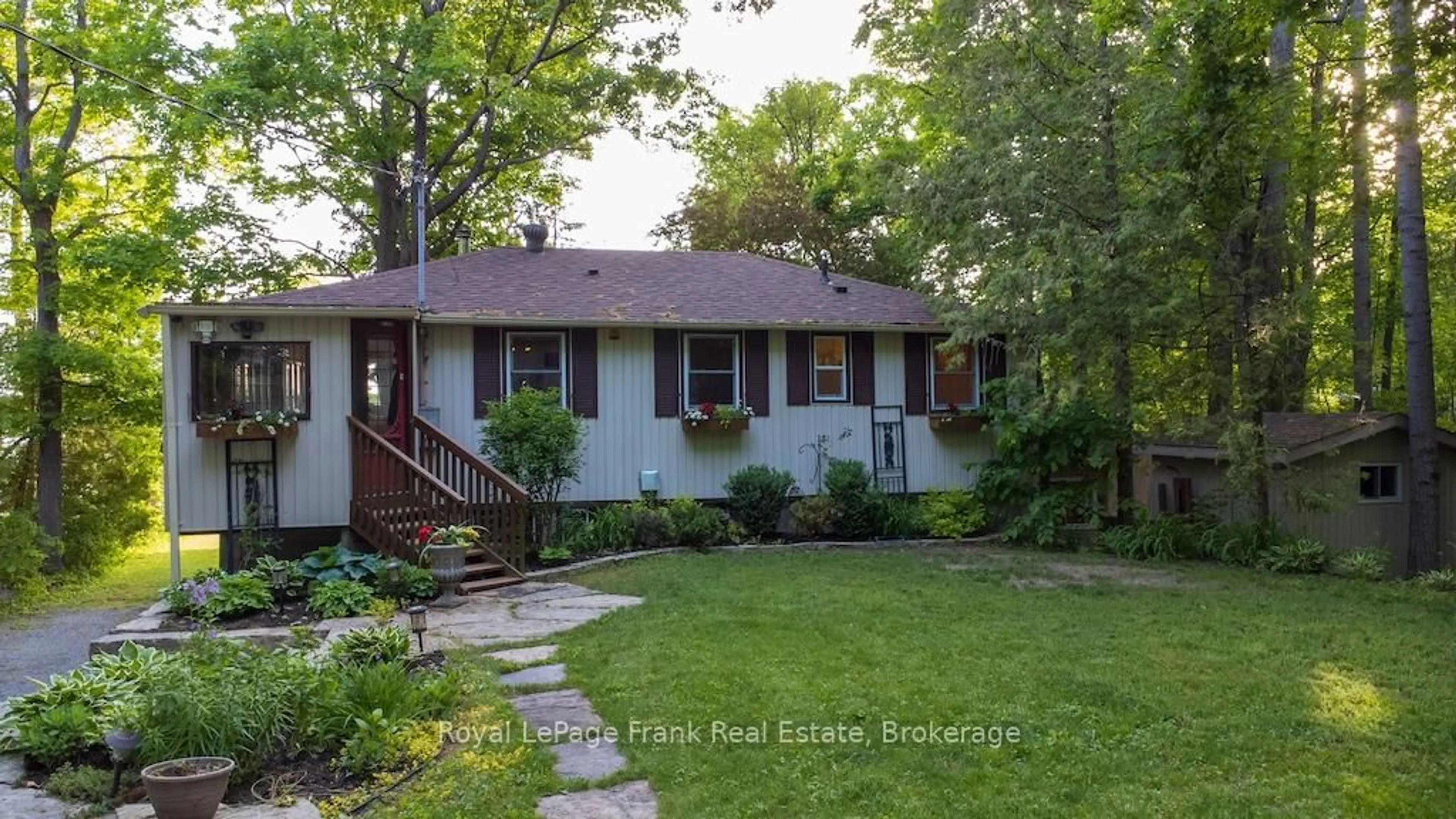 Home with vinyl exterior material, street for 12 Woodland Tr, Trent Lakes Ontario K0L 1J0
