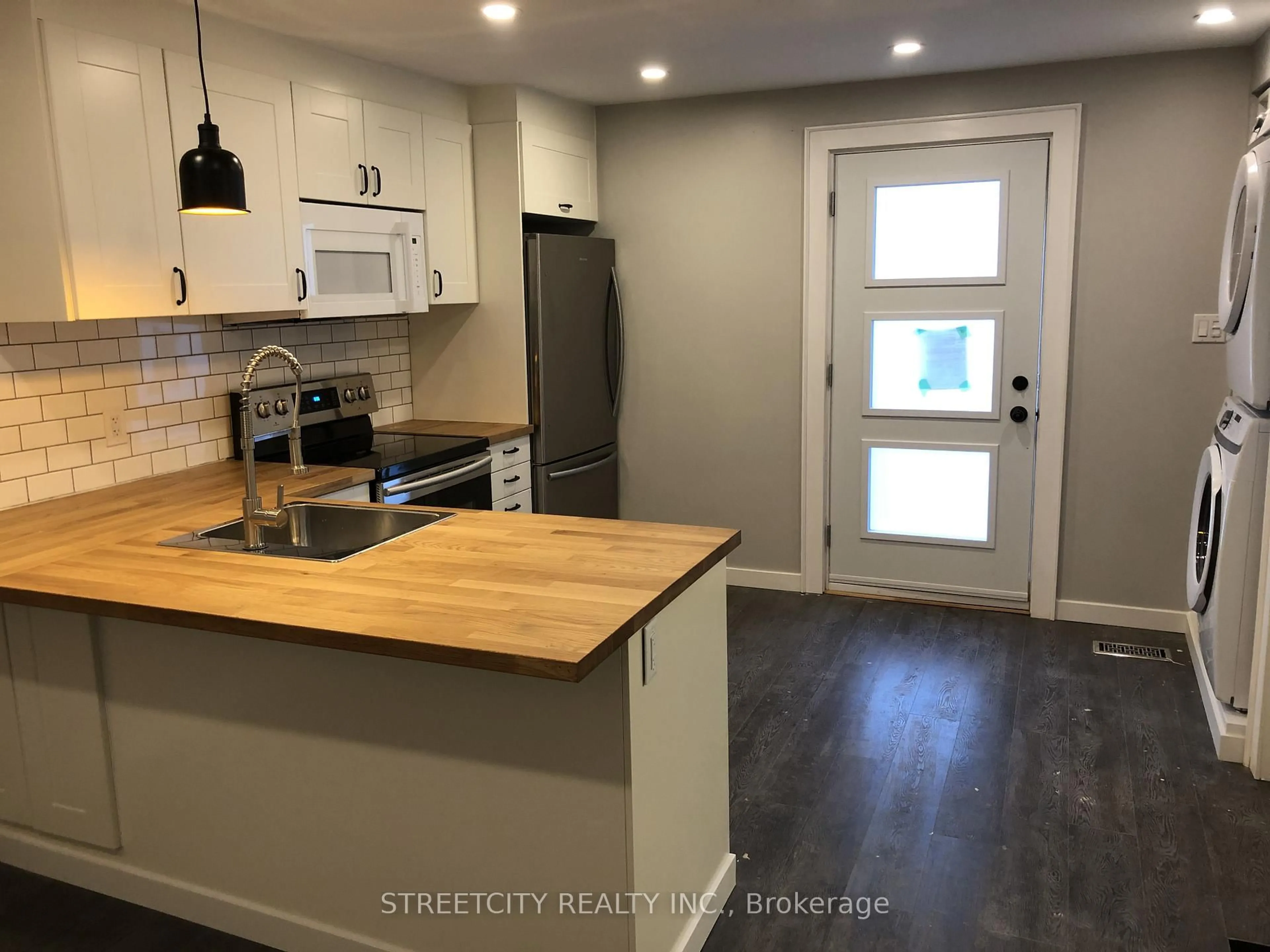 Open concept kitchen, wood/laminate floor for 163 Emerson St, London South Ontario N5Z 3L5