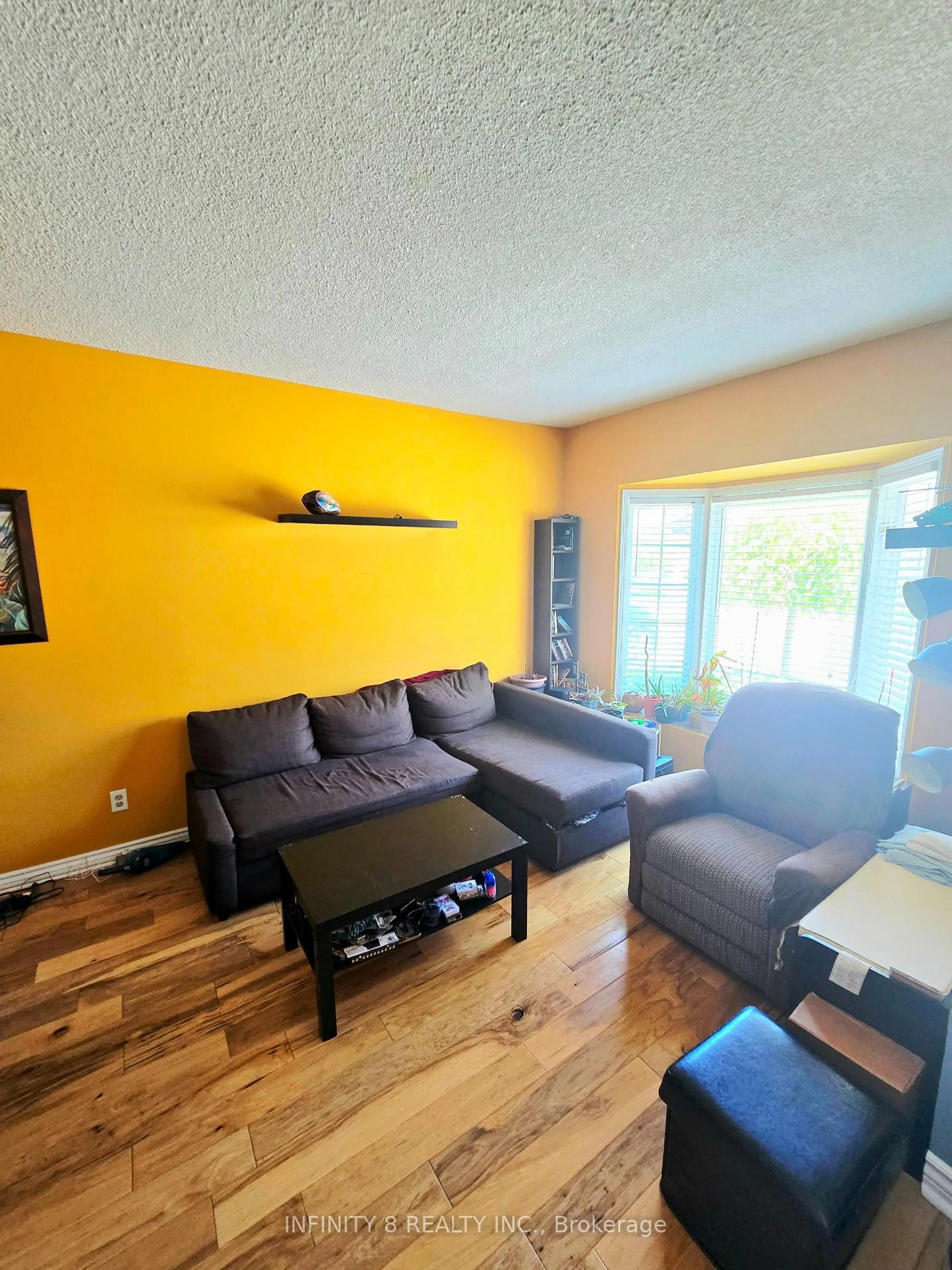 Living room with furniture, wood/laminate floor for 6910 Kalar Rd #12, Niagara Falls Ontario L2H 2T7
