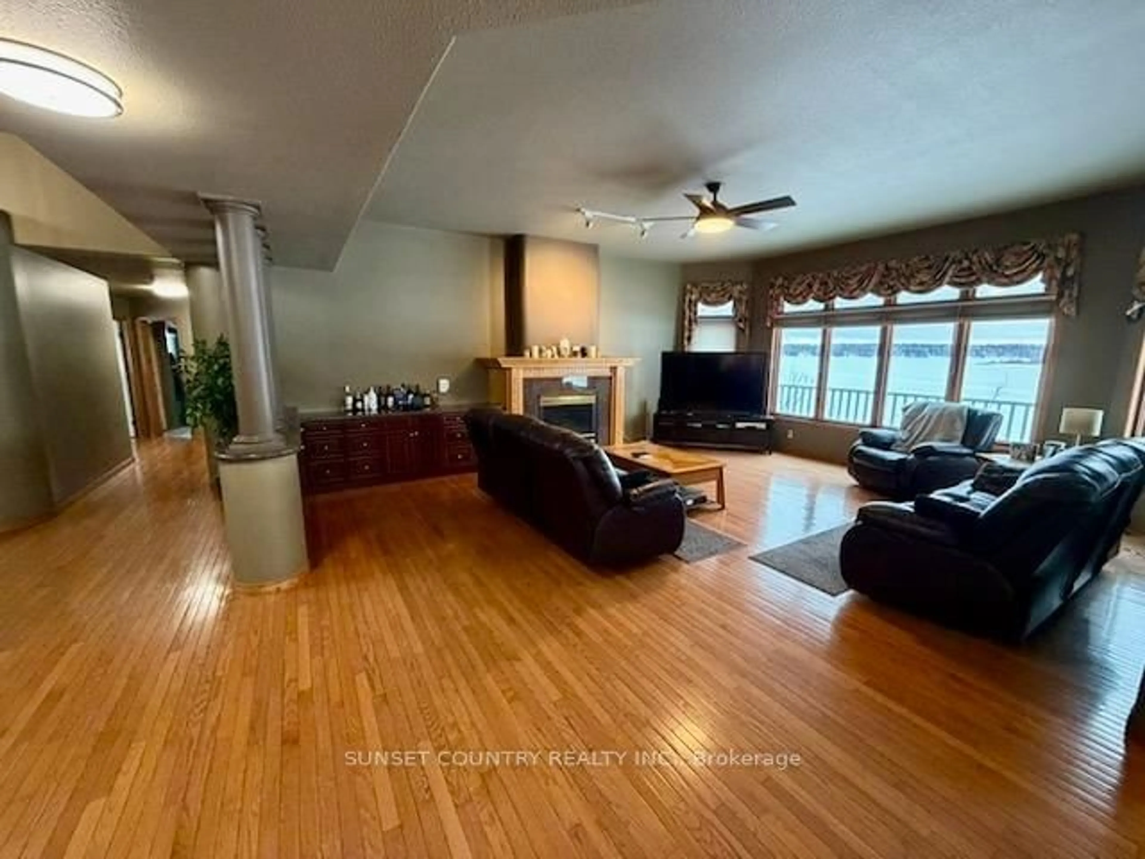 Living room with furniture, wood/laminate floor for 92 Edgewater Dr, Dryden Ontario P8N 3K2