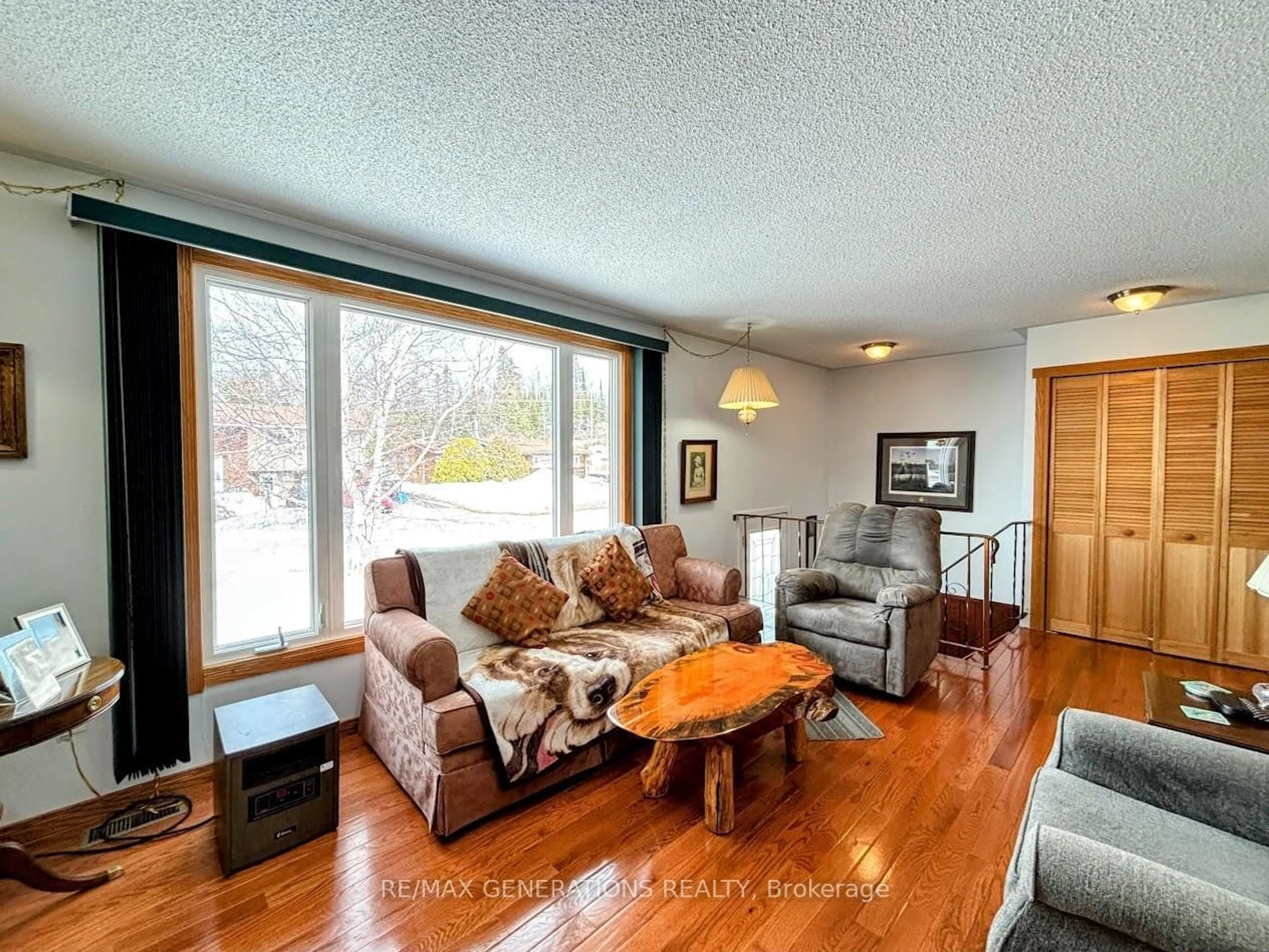 Living room with furniture, wood/laminate floor for 14 Lloyd Irwin St, Marathon Ontario P0T 2E0