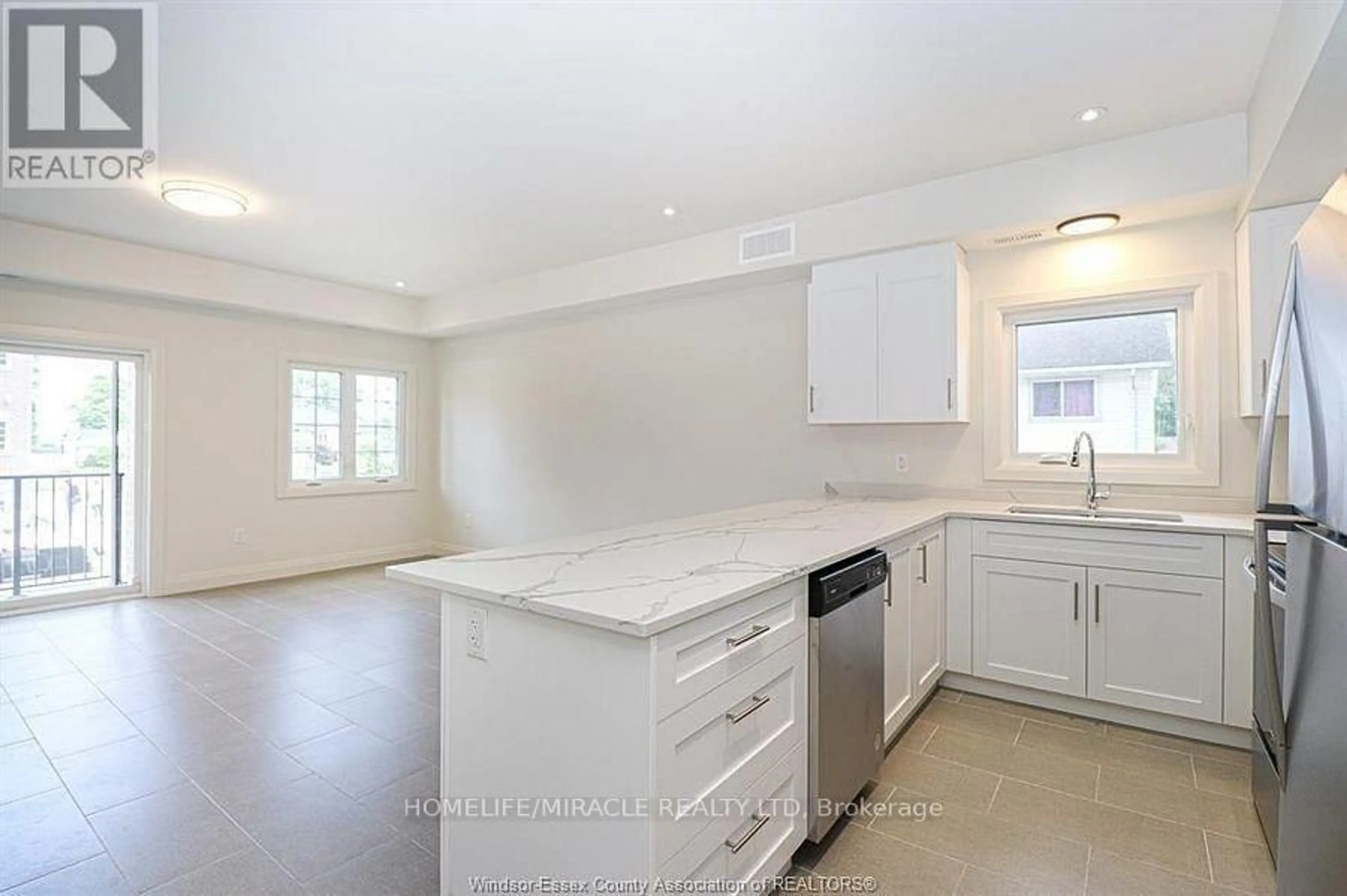 Open concept kitchen, ceramic/tile floor for 233 Watson Ave #204, Windsor Ontario N8S 3R8