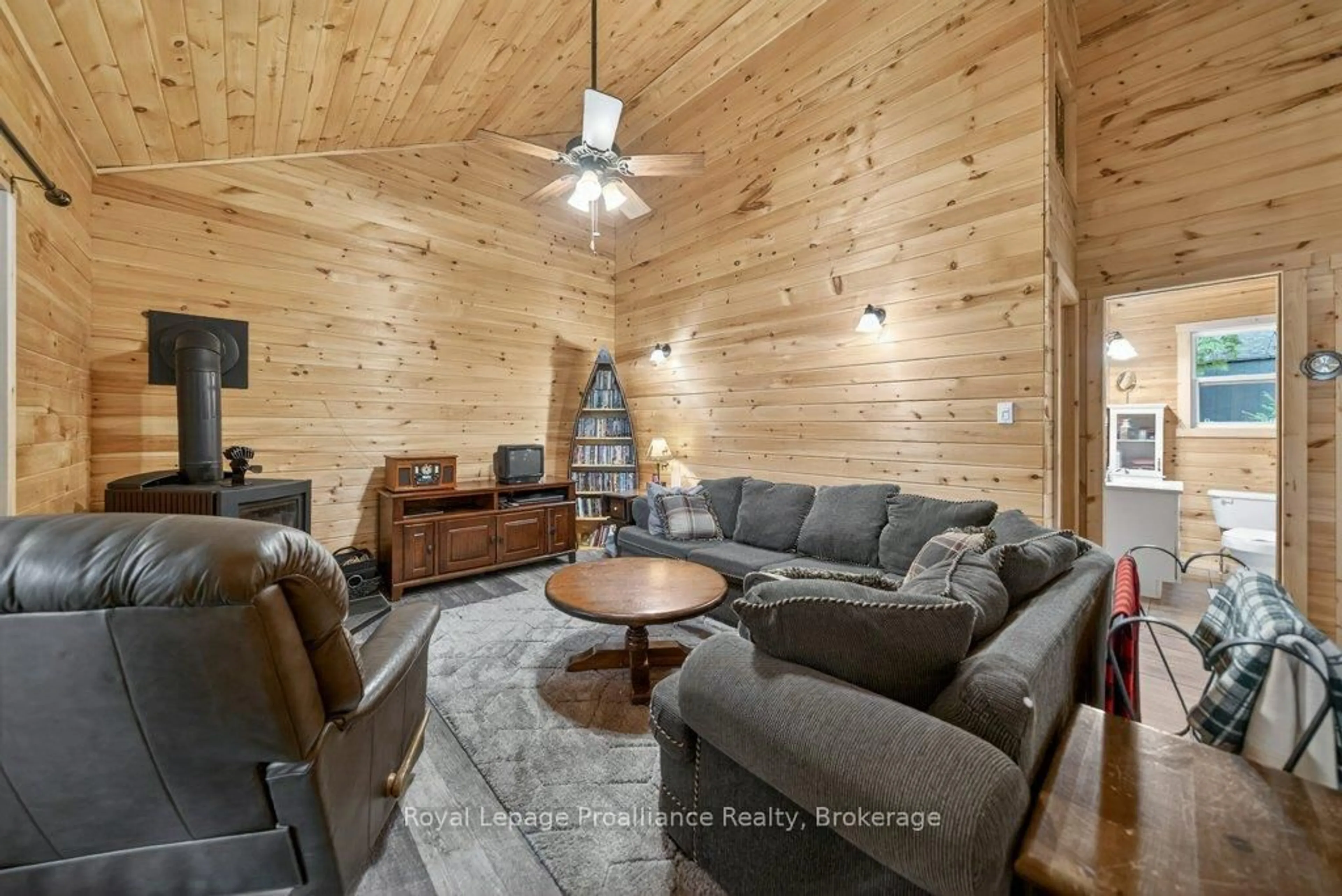 Living room with furniture, wood/laminate floor for 1051B Hereford Highland Lane, Ardoch Ontario K0H 1C0