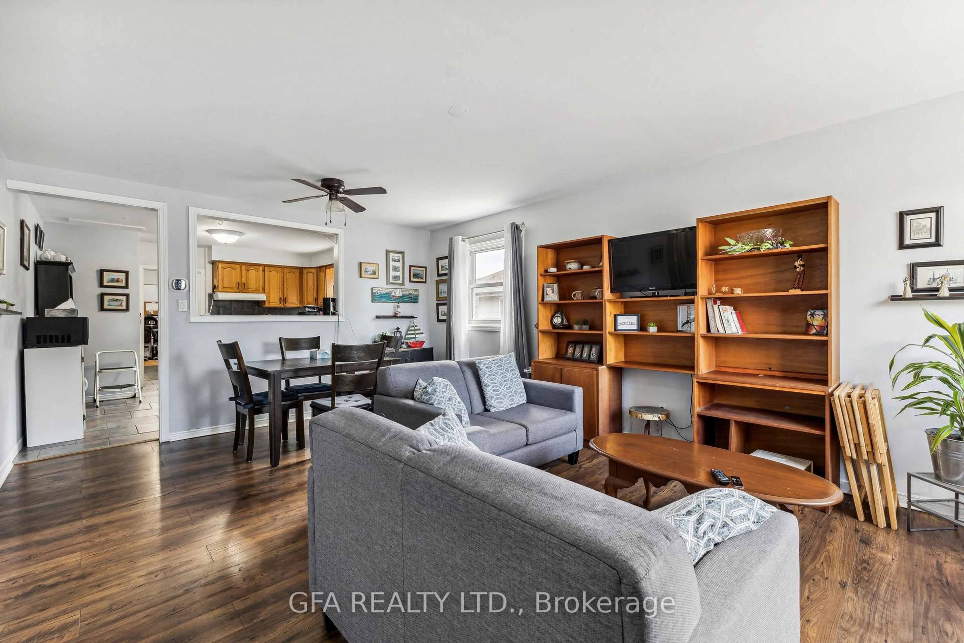 Living room with furniture, wood/laminate floor for 313 Upper Gage Ave, Hamilton Ontario L8V 4H6