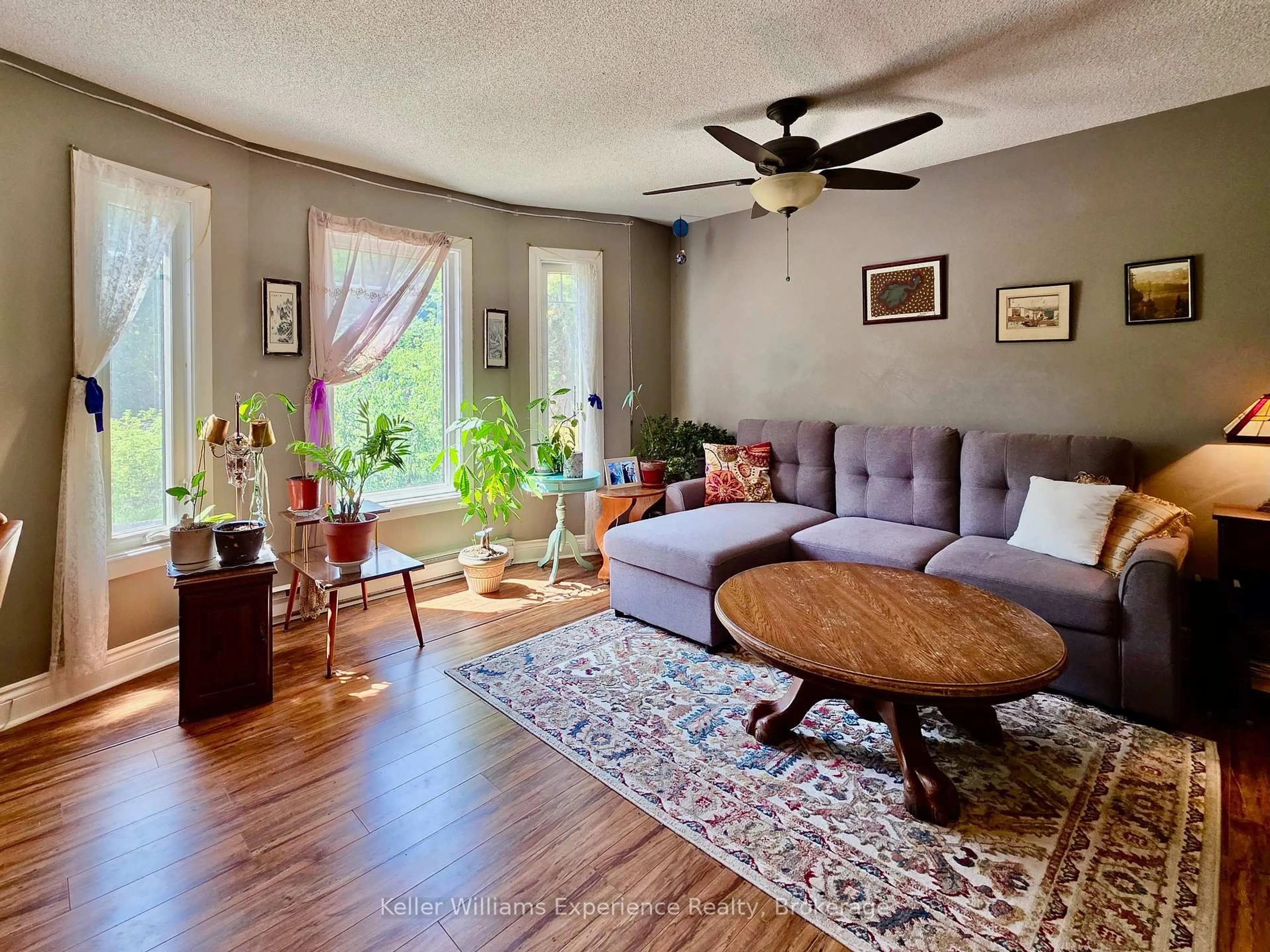 Living room with furniture, wood/laminate floor for 661 Cedar Lane #102C, Bracebridge Ontario P1L 1N9