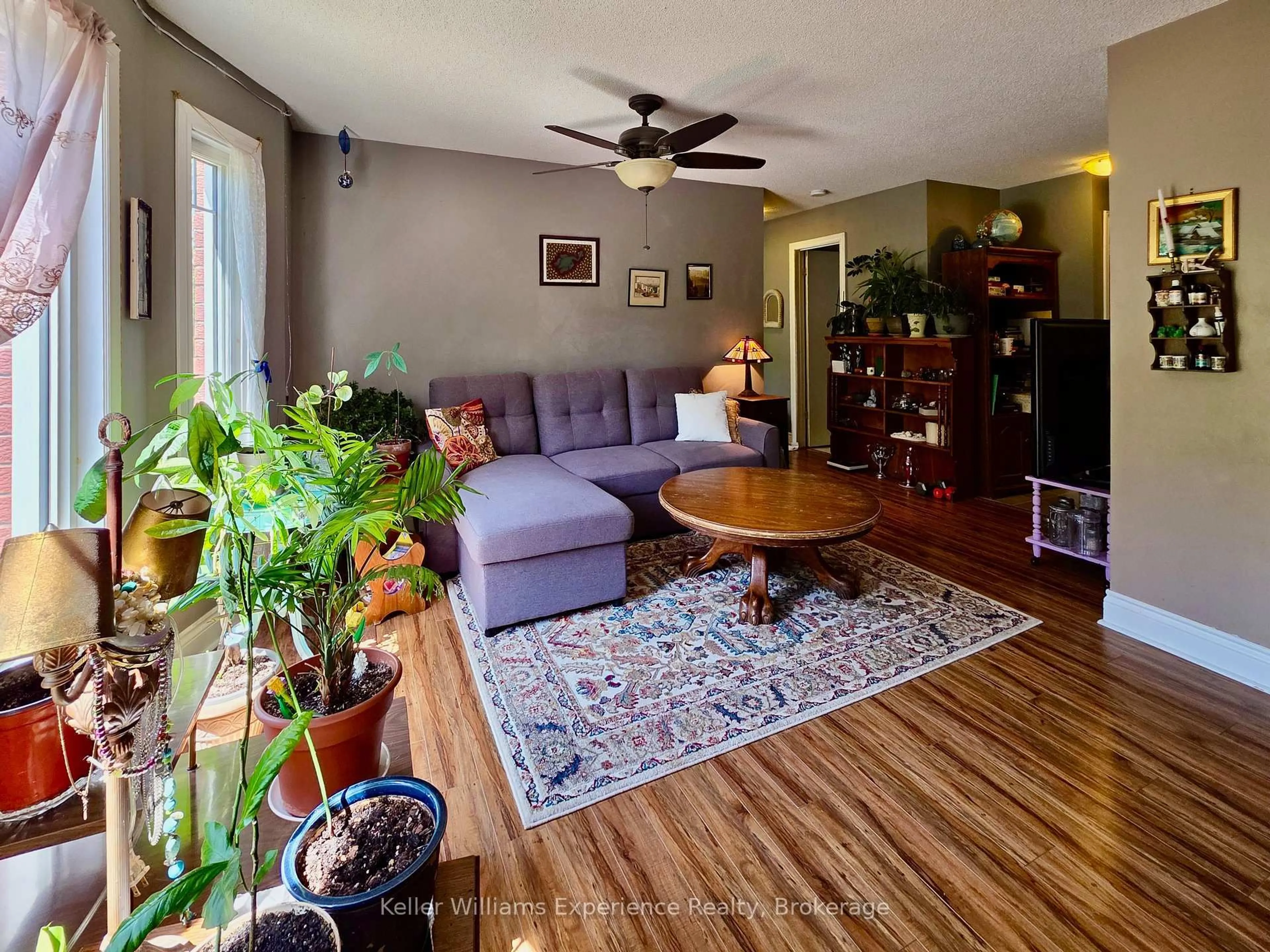 Living room with furniture, wood/laminate floor for 661 Cedar Lane #102C, Bracebridge Ontario P1L 1N9