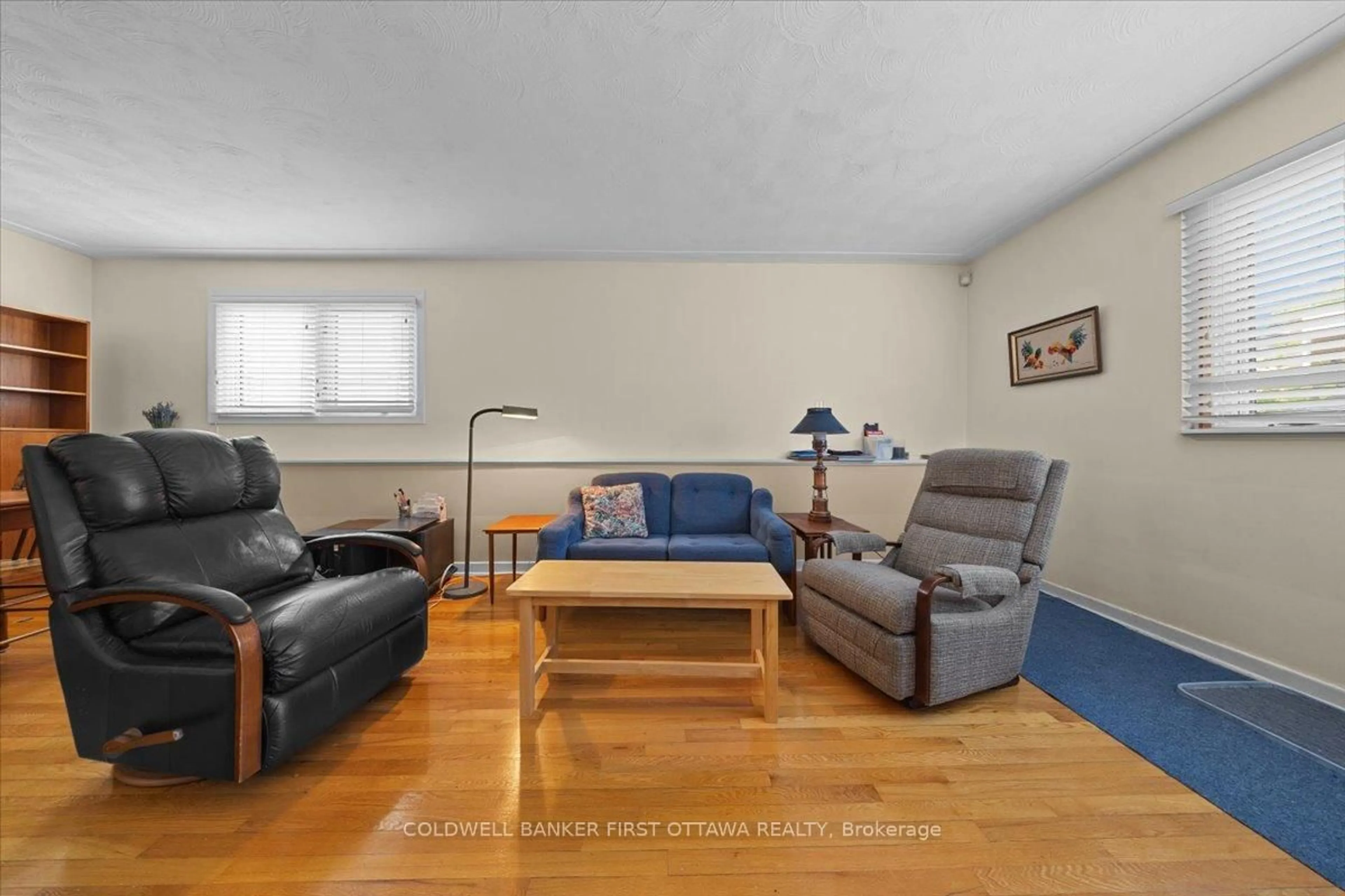 Living room with furniture, wood/laminate floor for 832 Ivanhoe Ave, Ottawa Ontario K2B 5S3